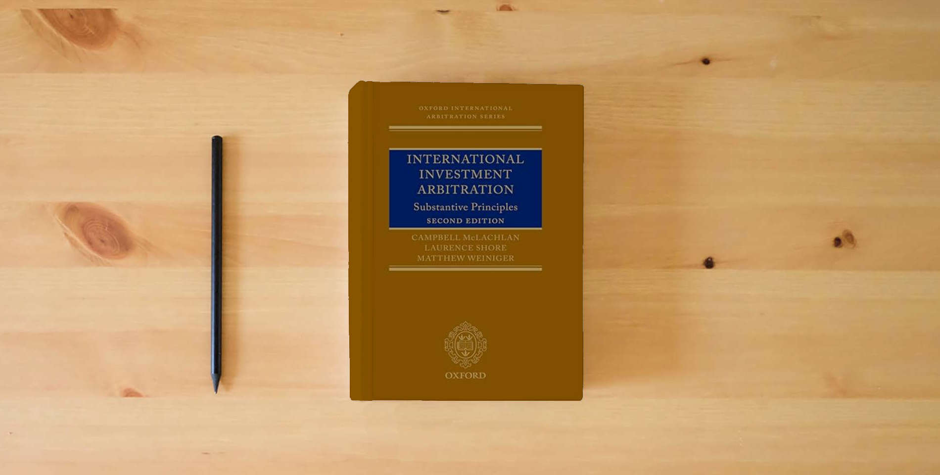 The book International Investment Arbitration: Substantive Principles (Oxford International Arbitration Series) is on the table