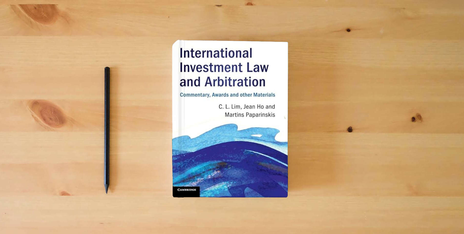 The book International Investment Law and Arbitration: Commentary, Awards and other Materials is on the table