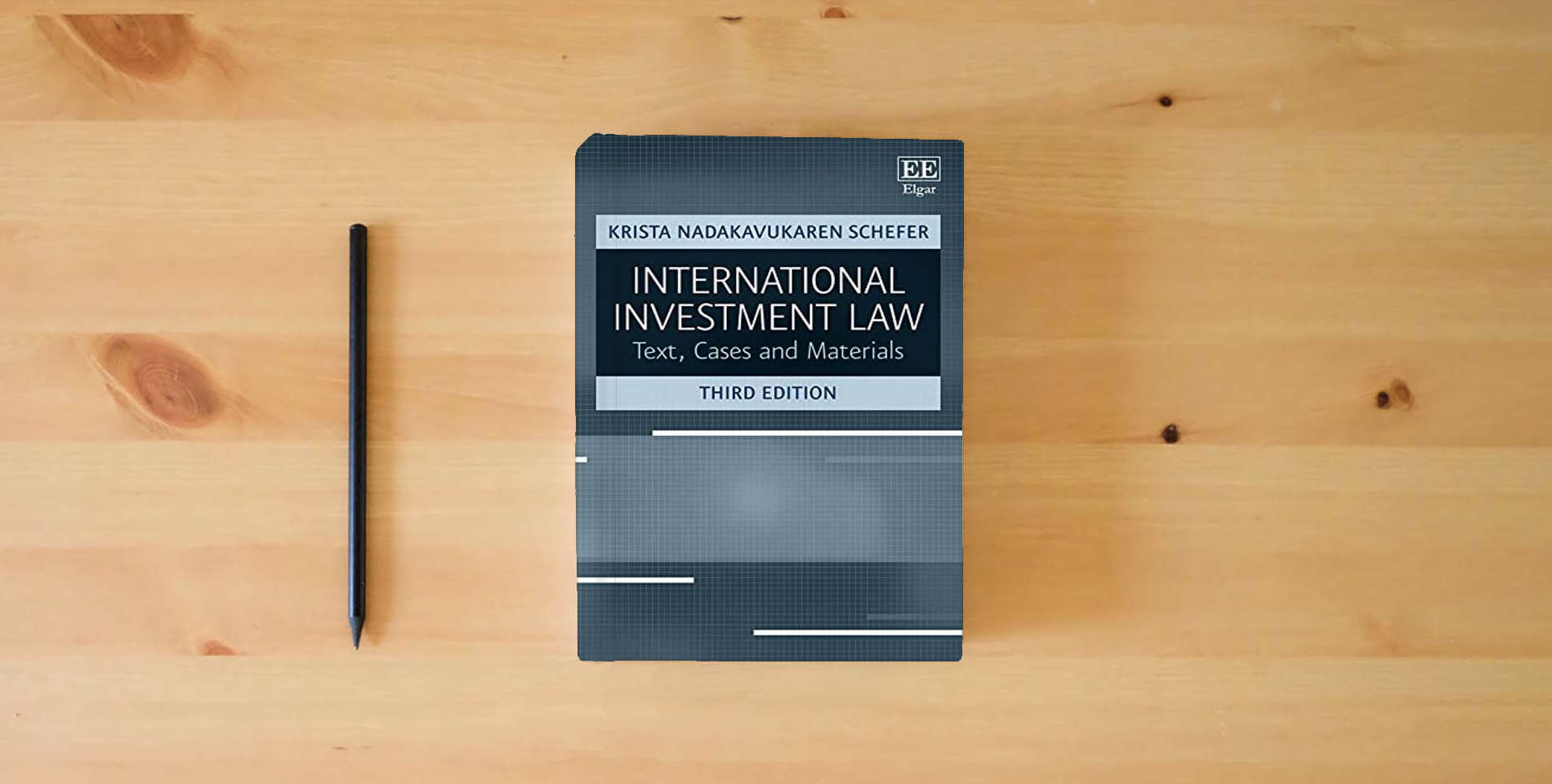 The book International Investment Law: Text, Cases and Materials, Third Edition is on the table