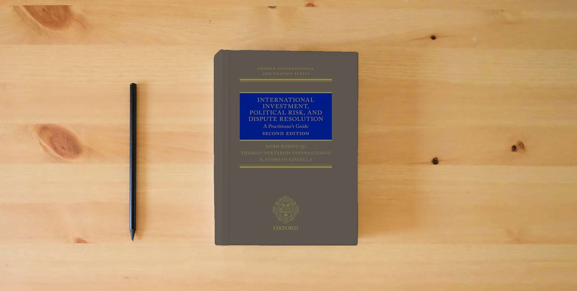 The book International Investment, Political Risk, and Dispute Resolution: A Practitioner's Guide (Oxford International Arbitration) is on the table