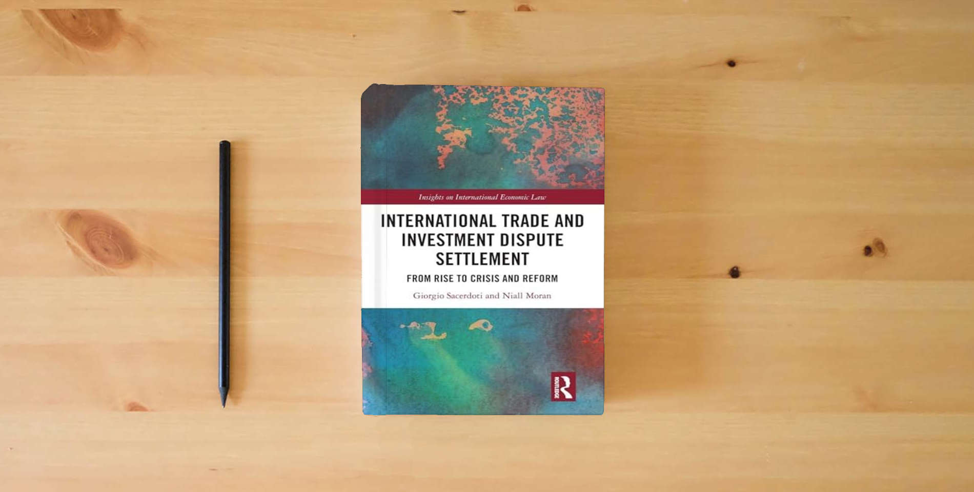 The book International Trade and Investment Dispute Settlement (Insights on International Economic Law) is on the table