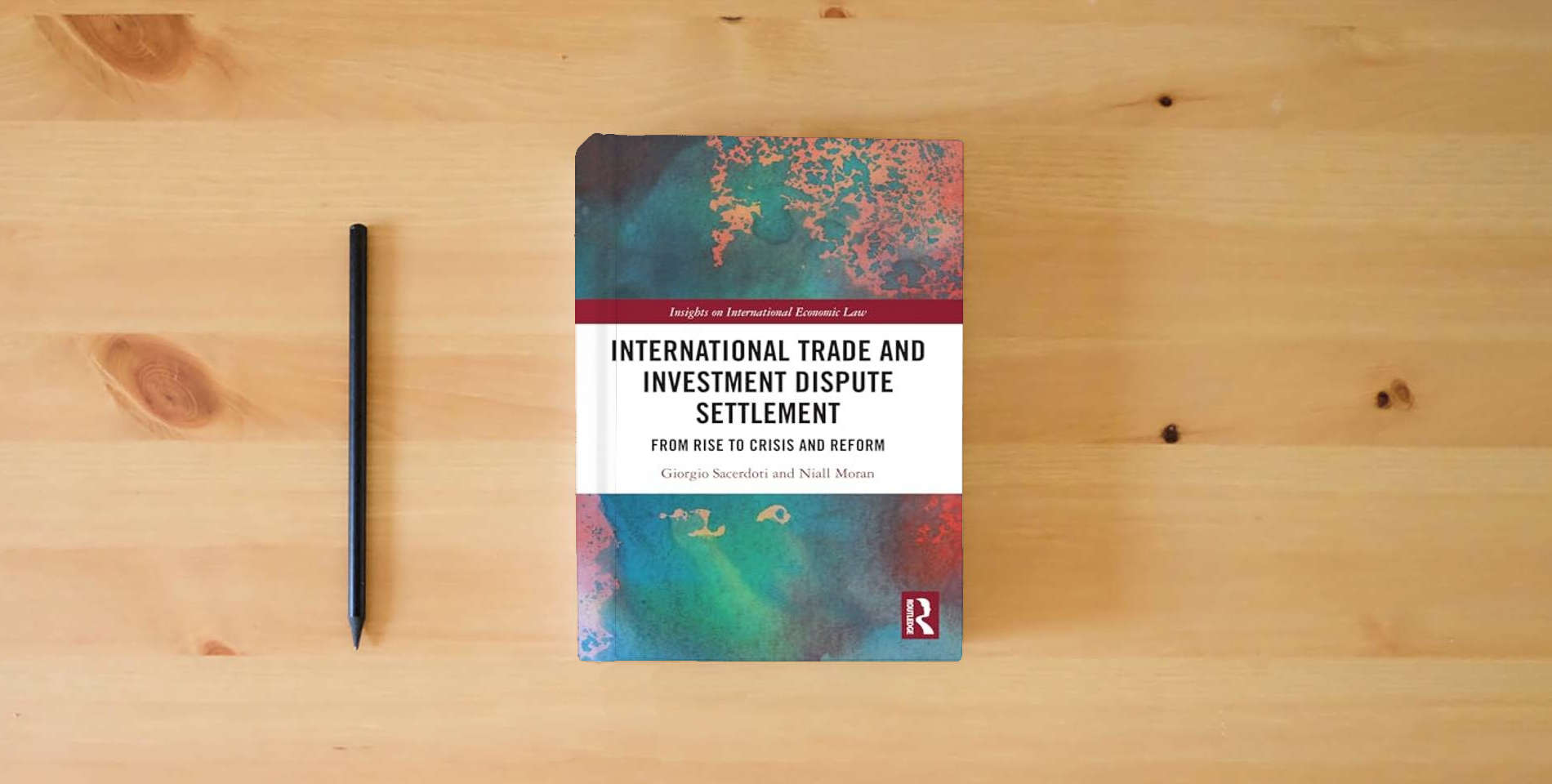 The book International Trade and Investment Dispute Settlement (Insights on International Economic Law) is on the table