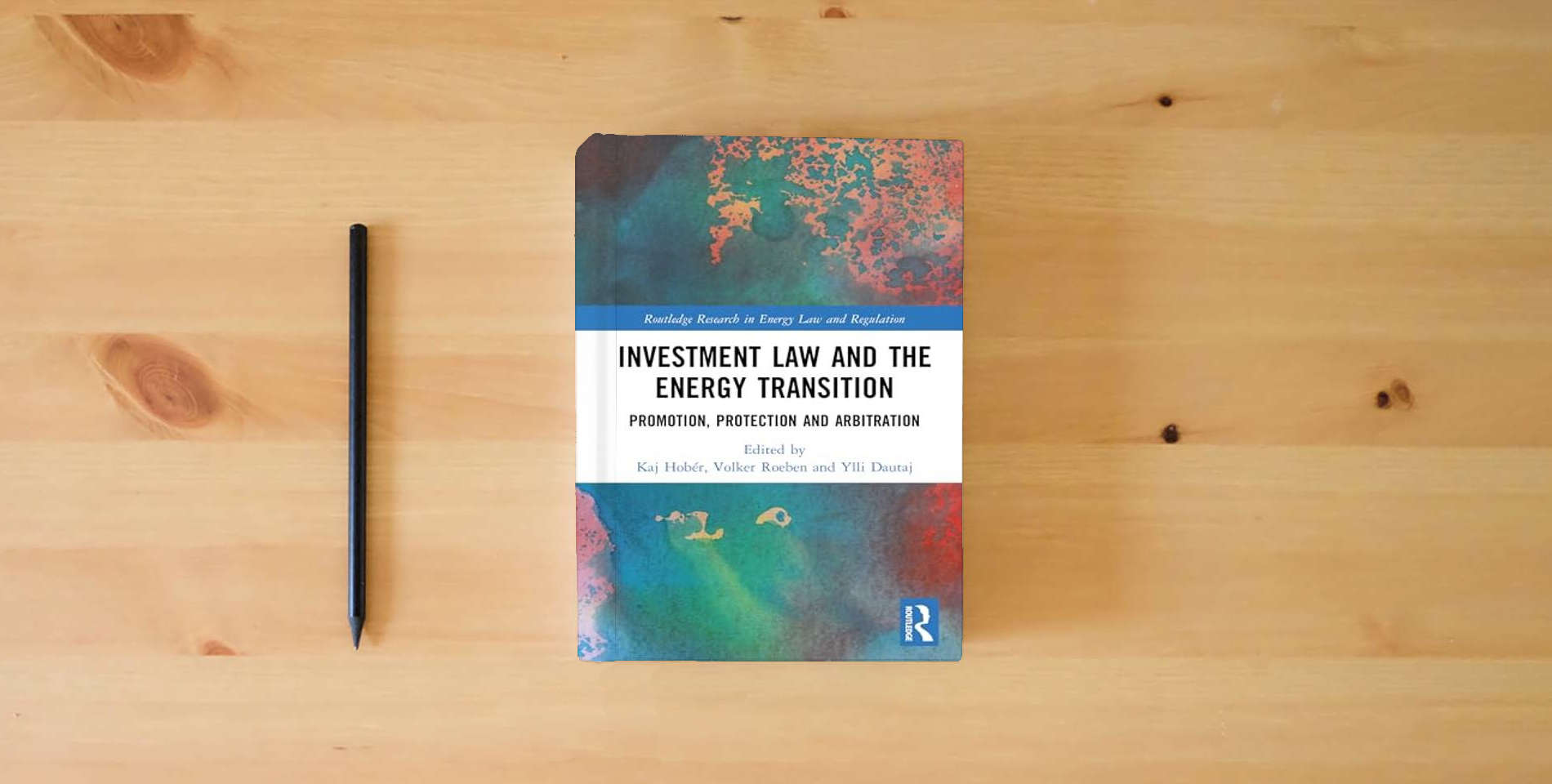 The book Investment Law and the Energy Transition: Promotion, Protection and Arbitration (Routledge Research in Energy Law and Regulation) is on the table