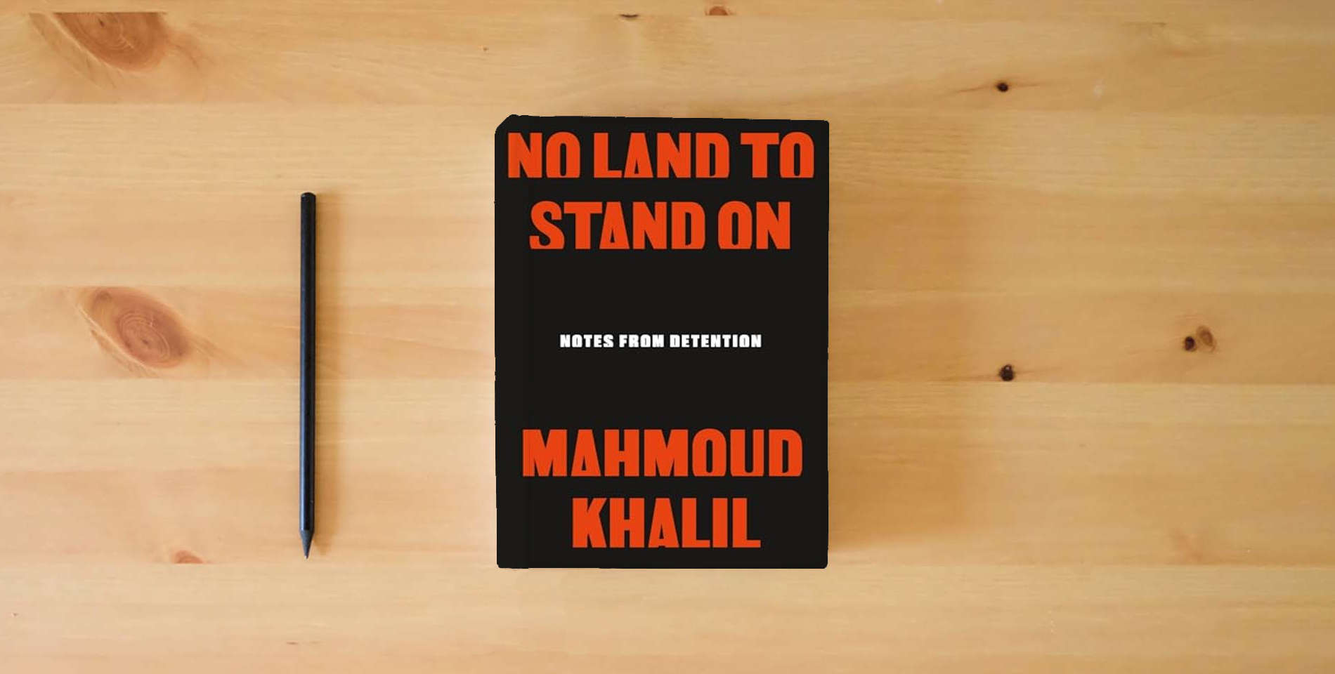 The book No Land to Stand On: Notes from Detention is on the table