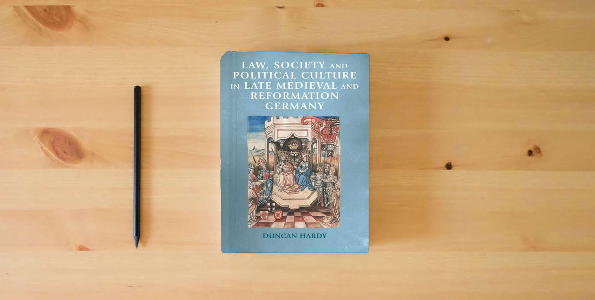 The book Law, society and political culture in late medieval and Reformation Germany (Manchester Medieval Sources) is on the table