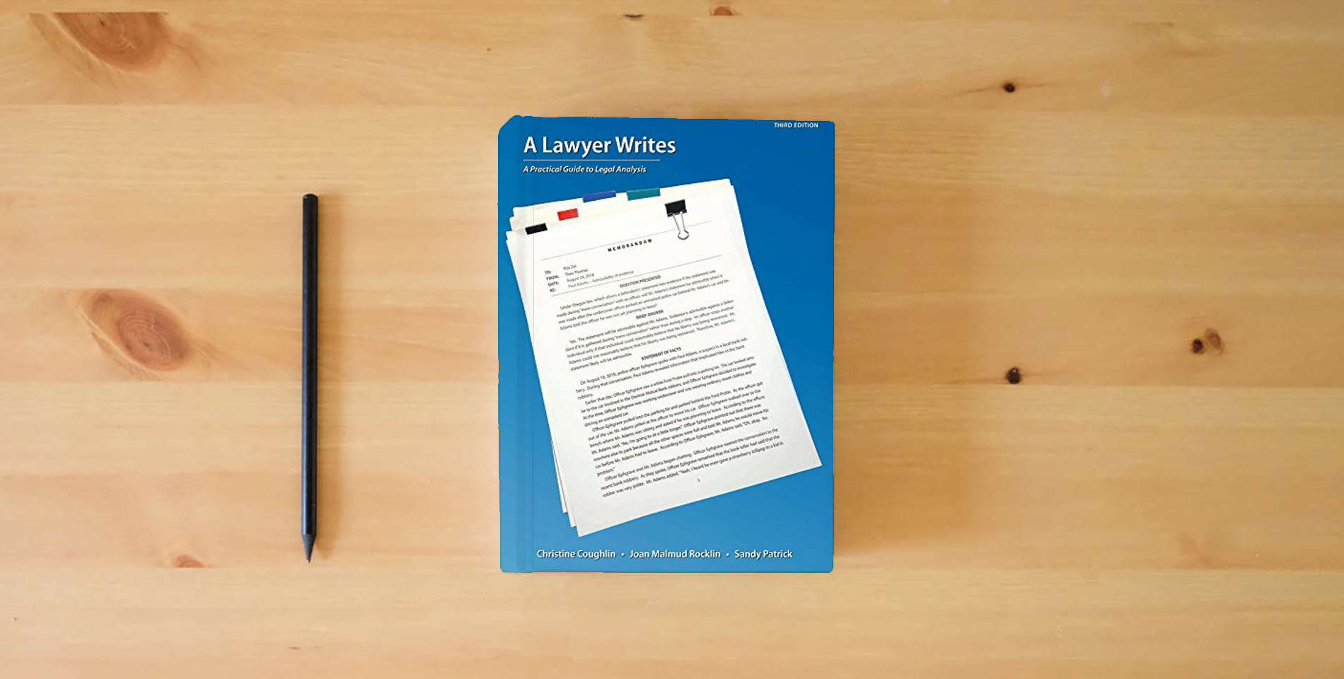 The book A Lawyer Writes: A Practical Guide to Legal Analysis is on the table