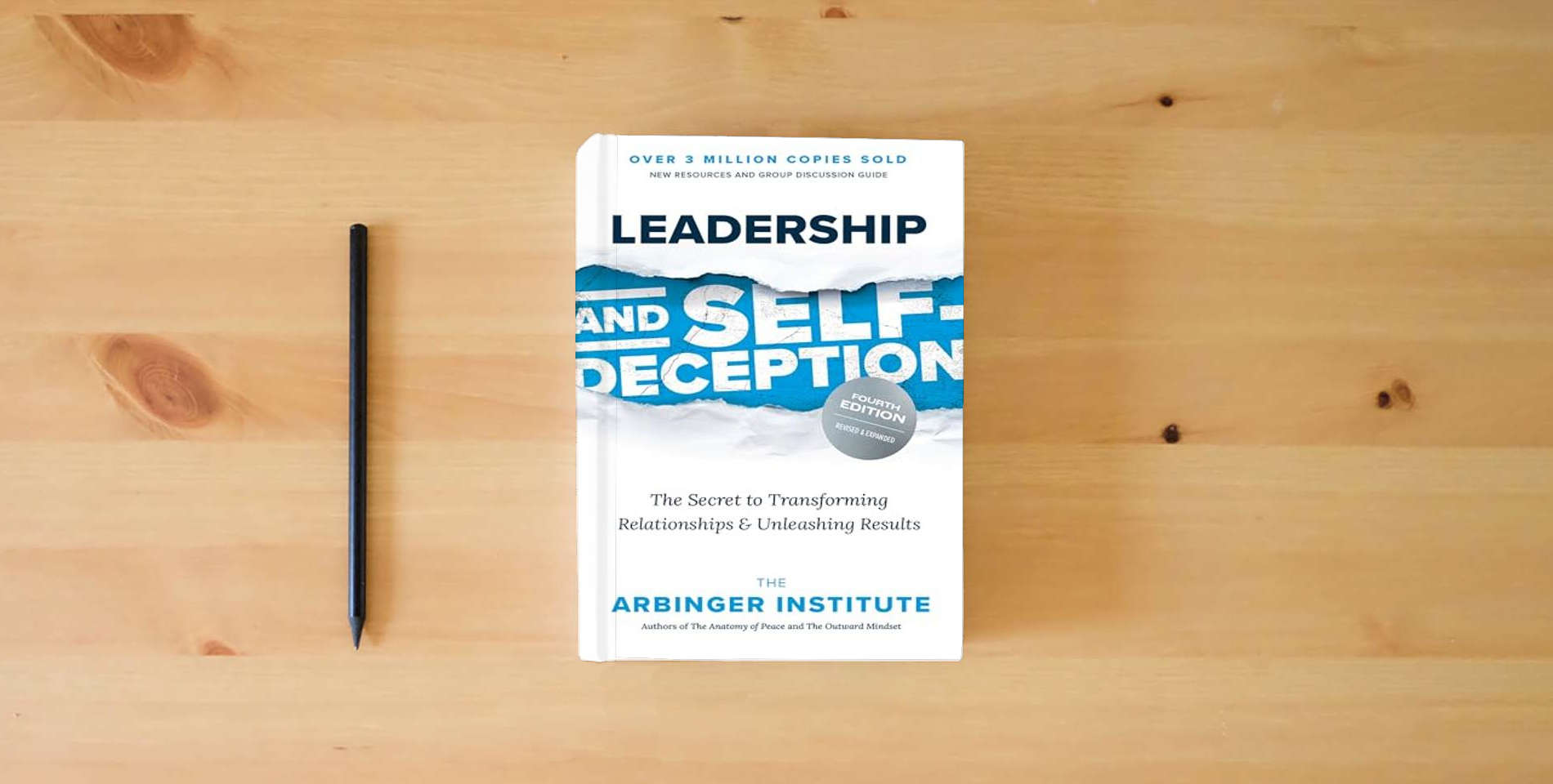 The book Leadership and Self-Deception, Fourth Edition: The Secret to Transforming Relationships and Unleashing Results is on the table