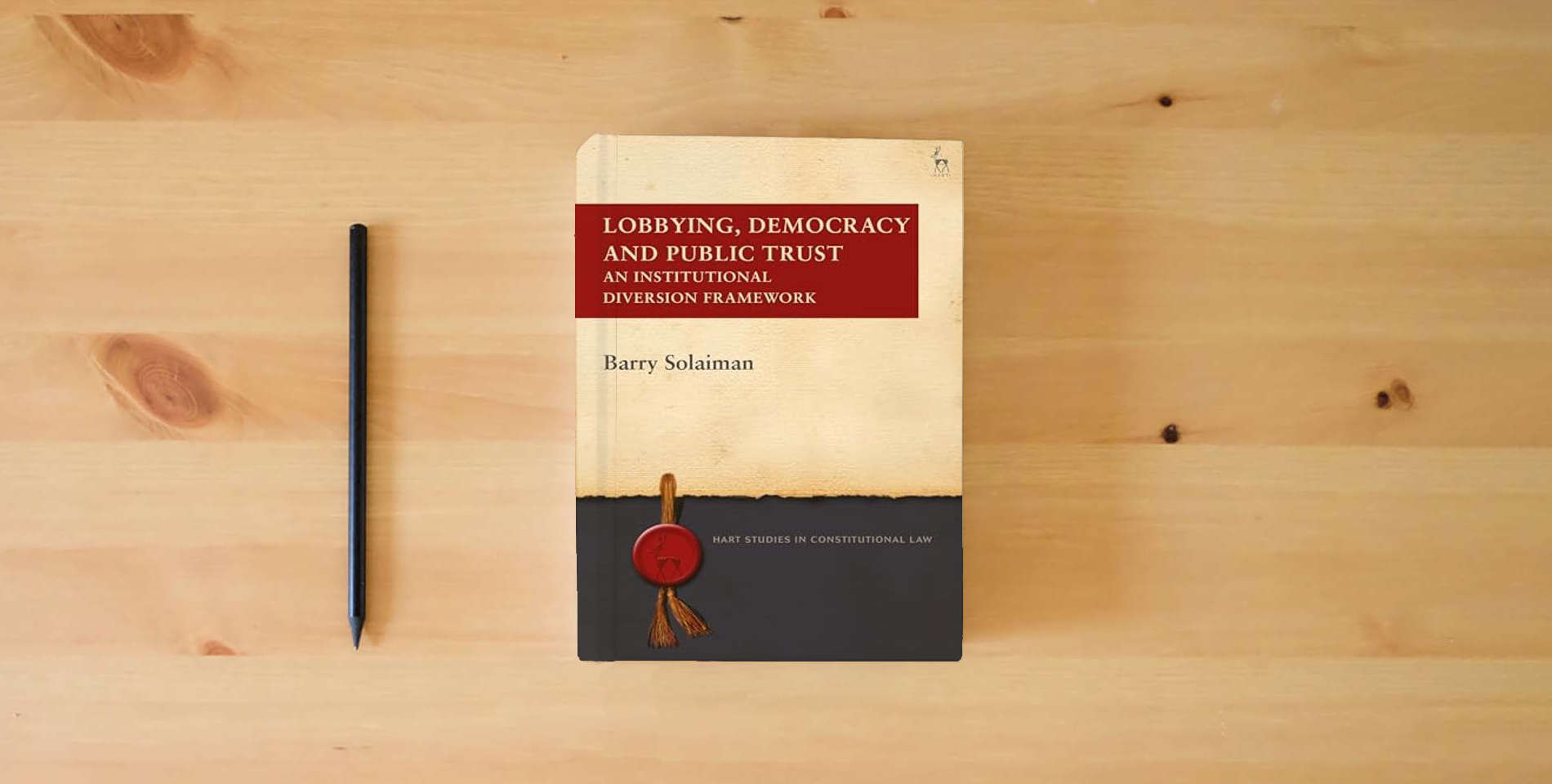 The book Lobbying, Democracy and Public Trust: An Institutional Diversion Framework (Hart Studies in Constitutional Law) is on the table