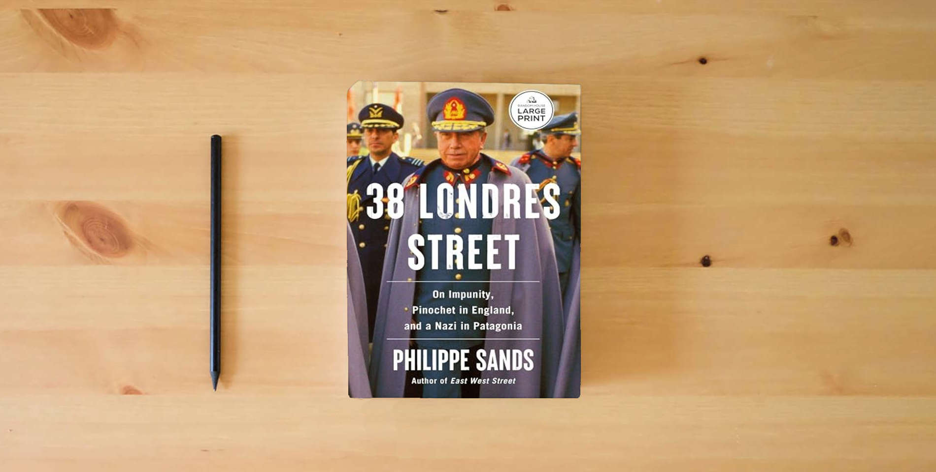 The book 38 Londres Street: On Impunity, Pinochet in England, and a Nazi in Patagonia is on the table
