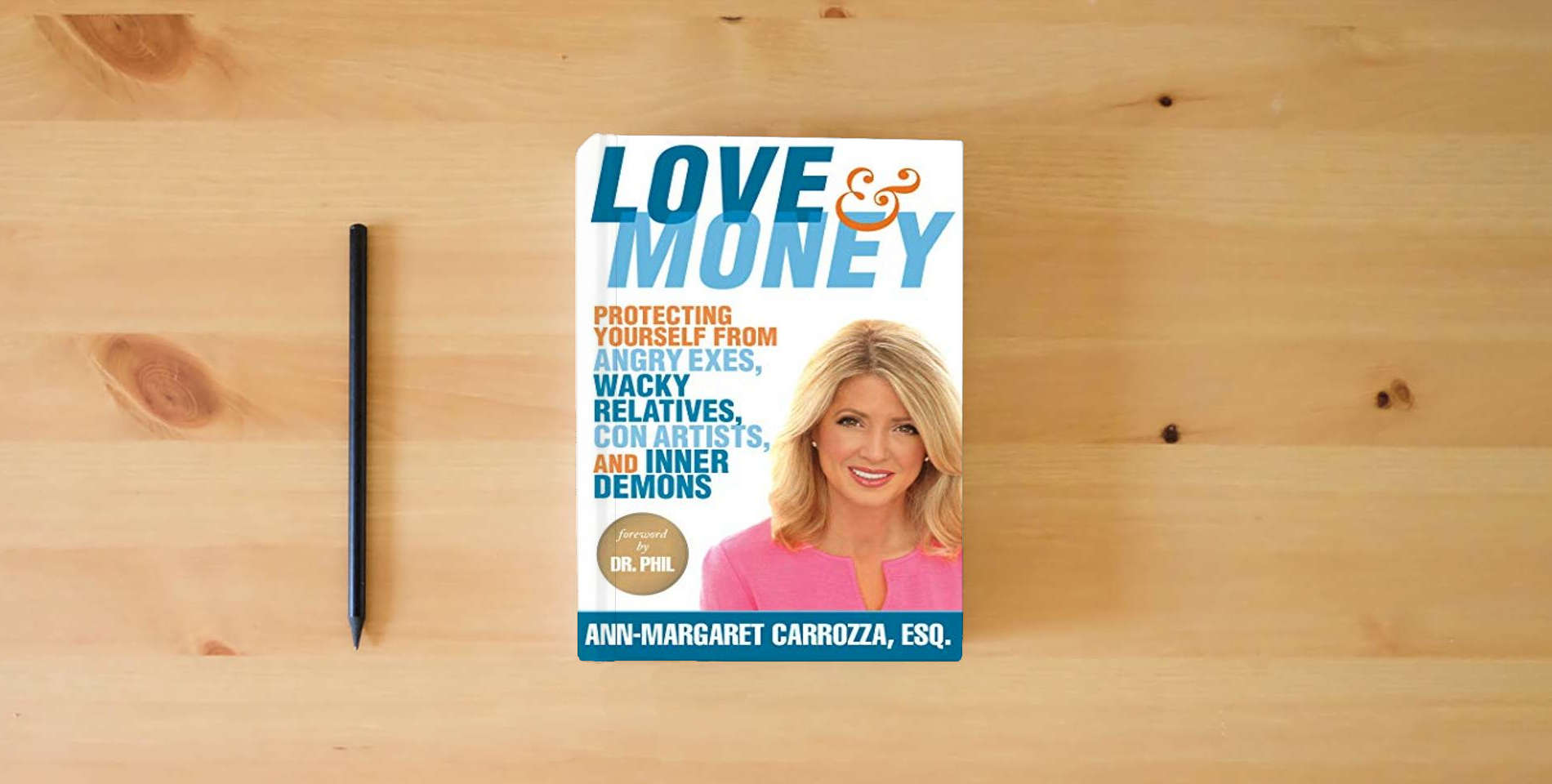 The book Love & Money: Protecting Yourself from Angry Exes, Wacky Relatives, Con Artists, and Inner Demons is on the table