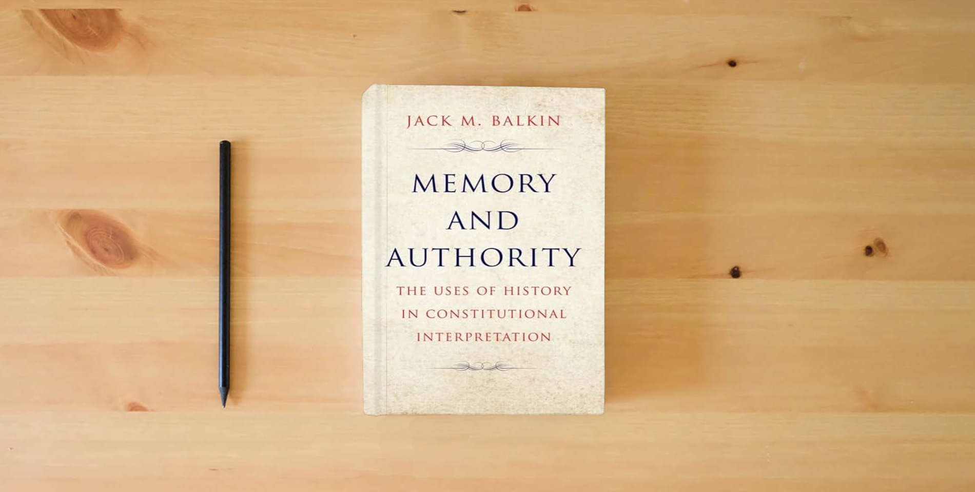 The book Memory and Authority: The Uses of History in Constitutional Interpretation (Yale Law Library Series in Legal History and Reference) is on the table