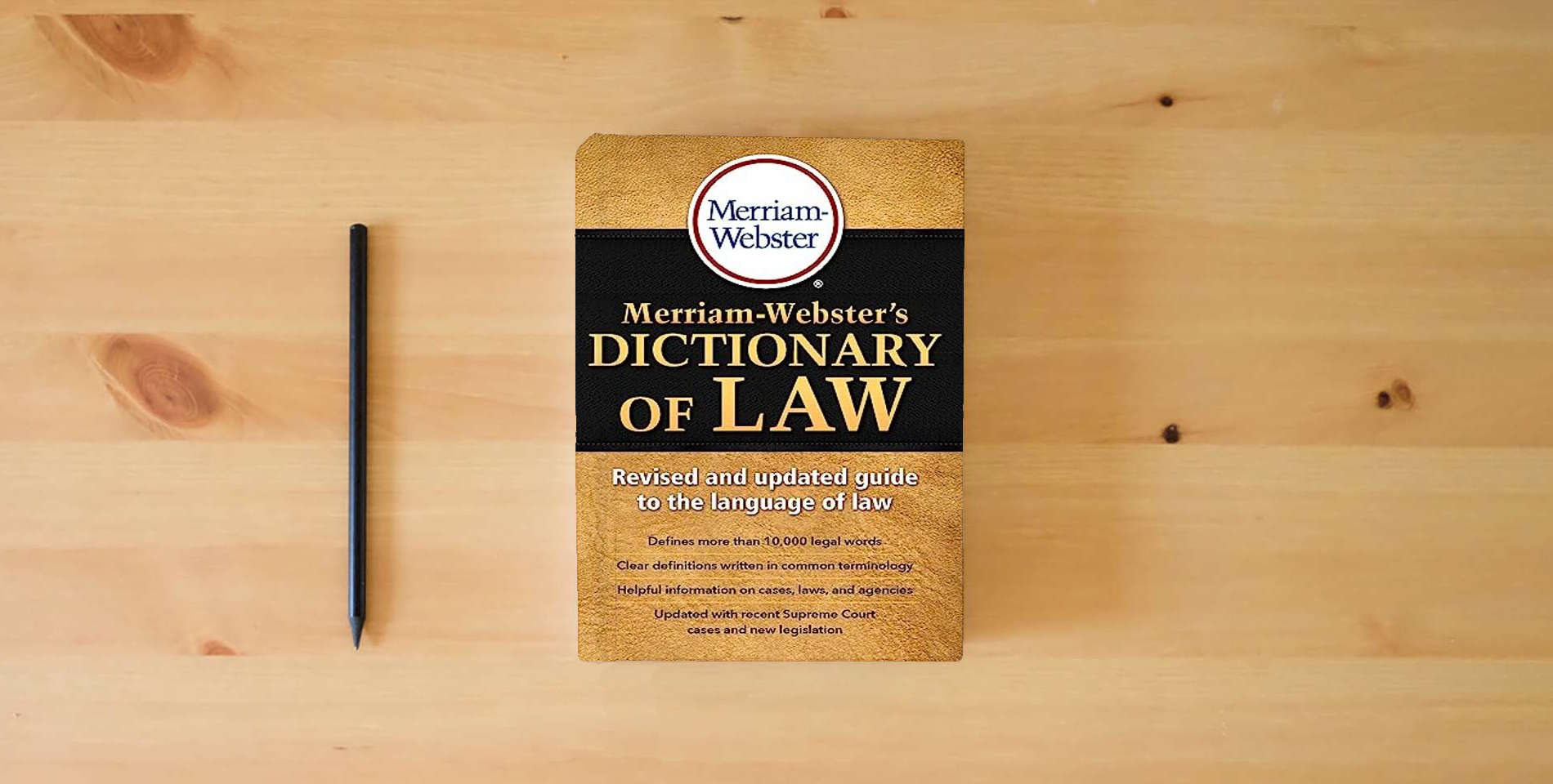 The book Merriam-Webster's Dictionary of Law, Newest Edition, Trade Paperback is on the table