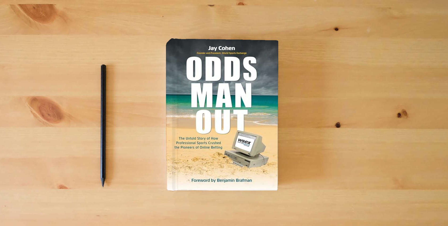 The book Odds Man Out: The Untold Story of How Professional Sports Crushed Betting's Online Pioneer is on the table