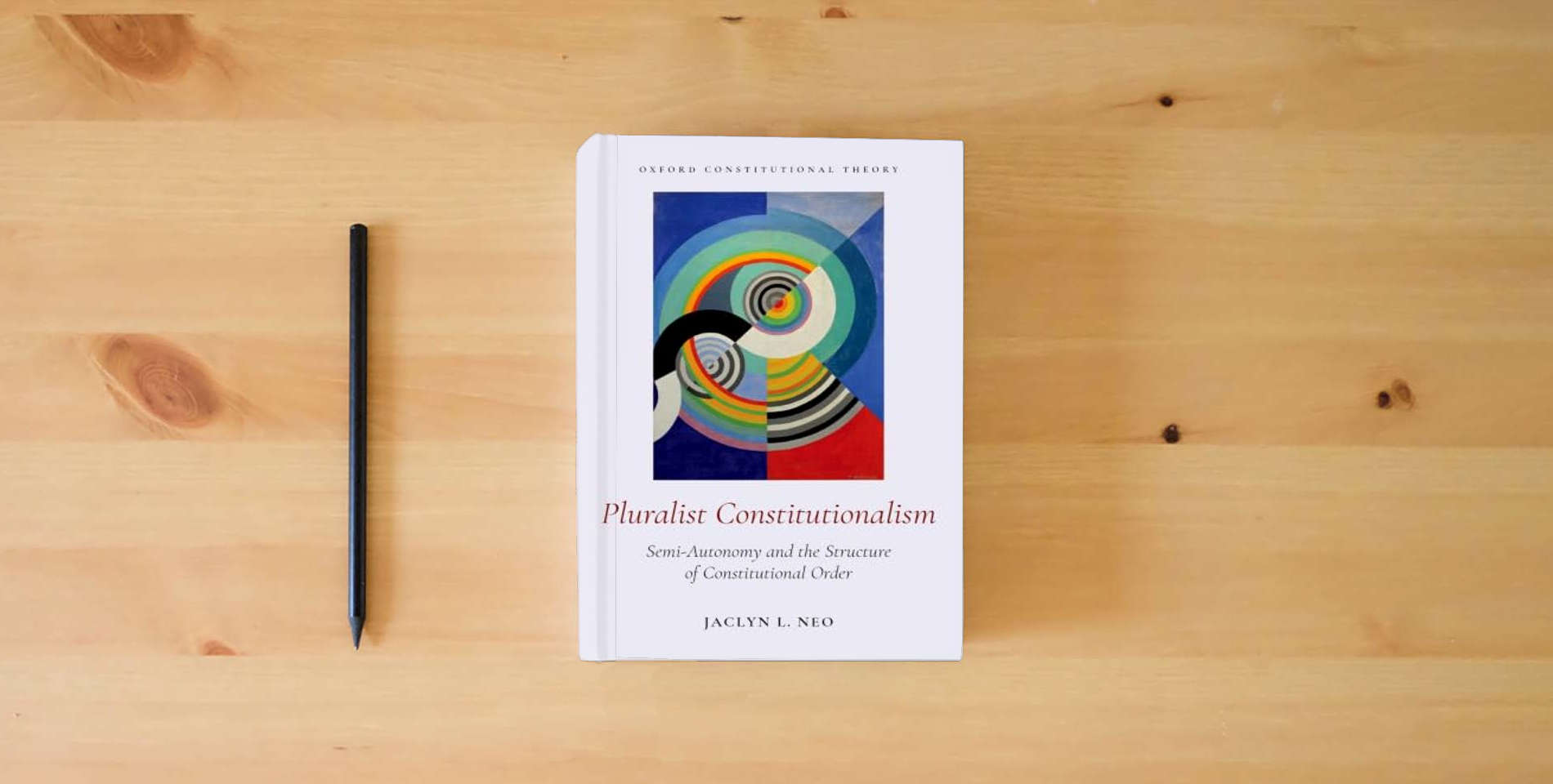 The book Pluralist Constitutionalism: Semi-Autonomy and the Structure of Constitutional Order (Oxford Constitutional Theory) is on the table