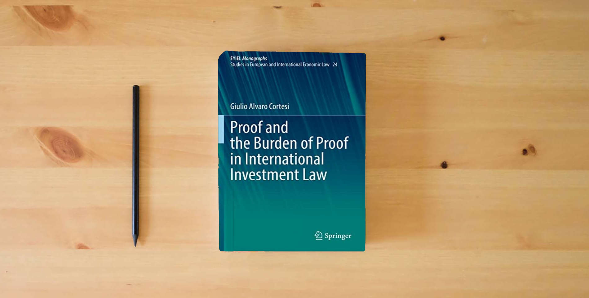 The book Proof and the Burden of Proof in International Investment Law (EYIEL Monographs - Studies in European and International Economic Law) is on the table