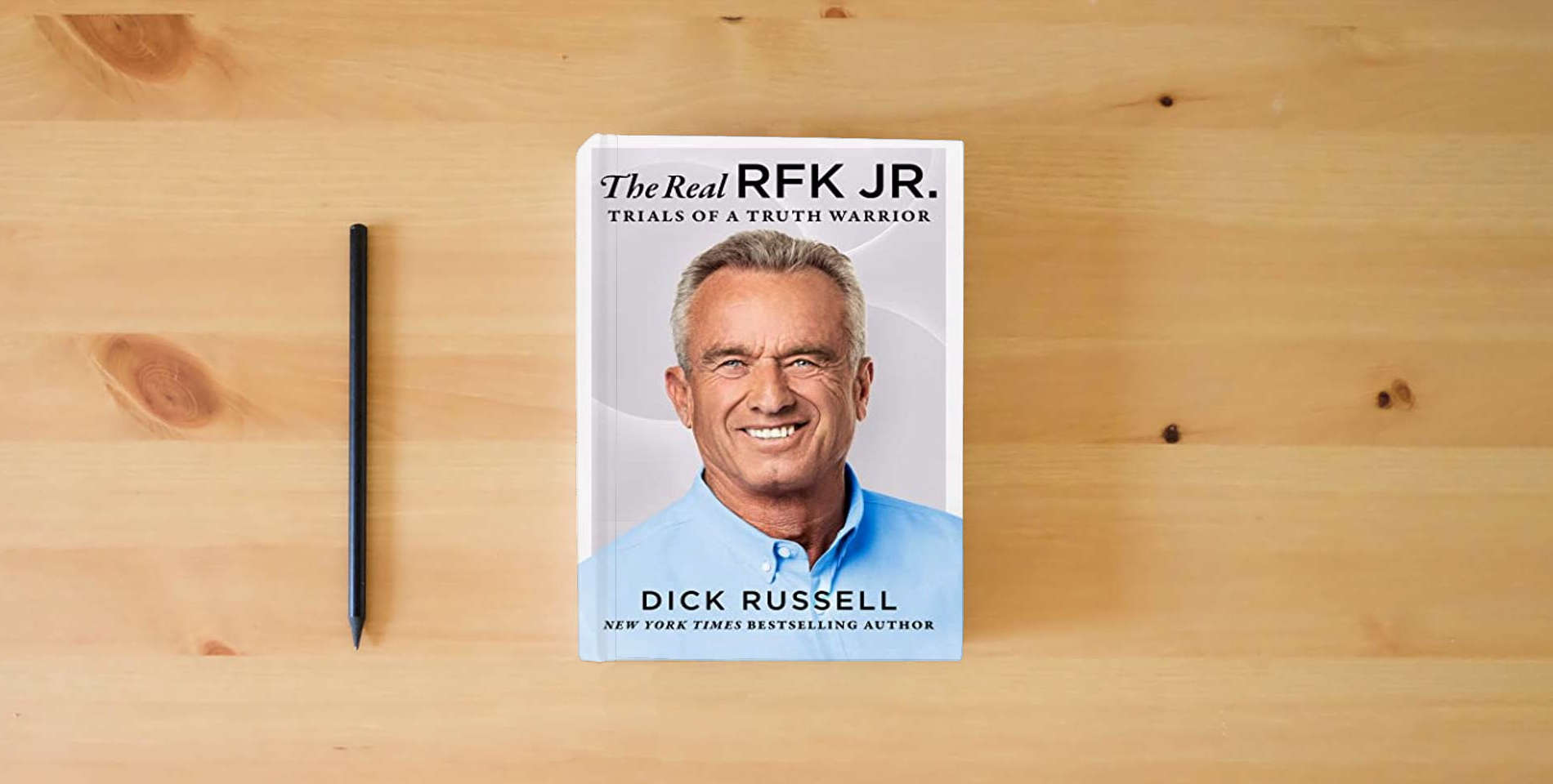 The book Real RFK Jr.: Trials of a Truth Warrior is on the table