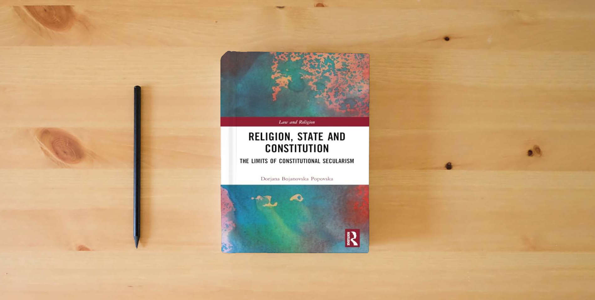 The book Religion, State and Constitution: The Limits of Constitutional Secularism (Law and Religion) is on the table