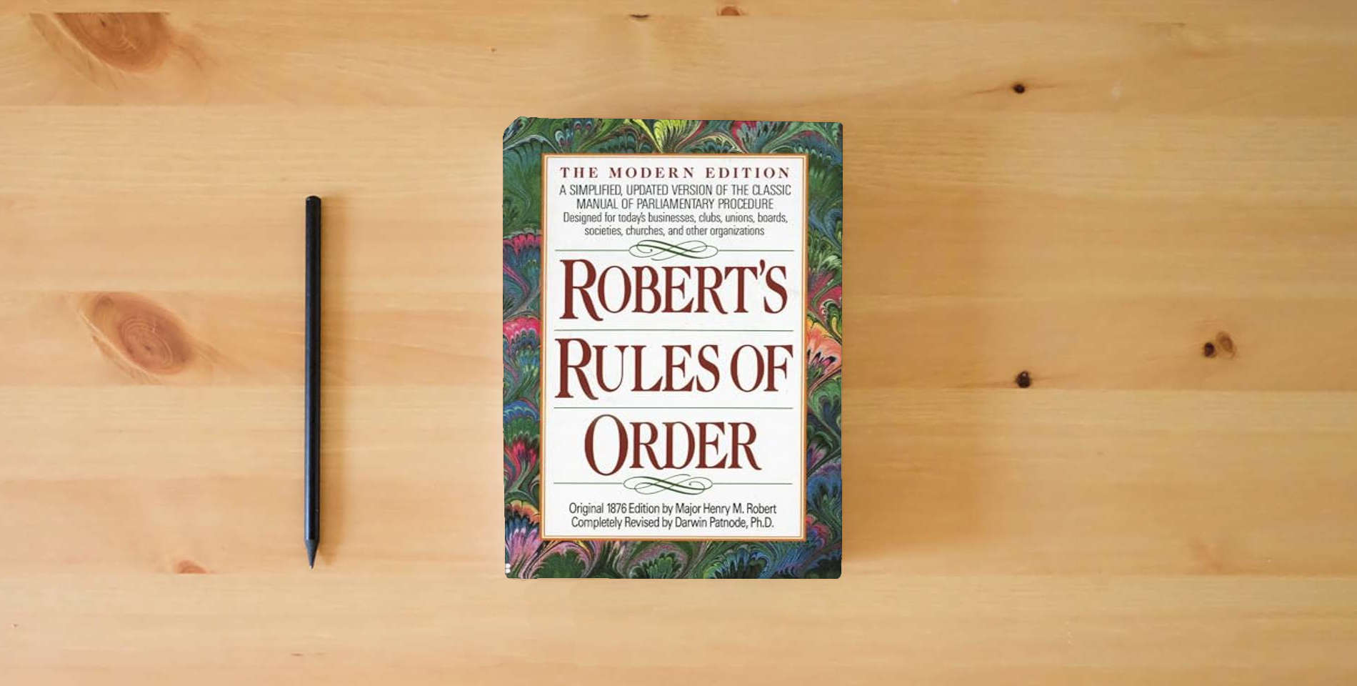 The book Robert's Rules of Order: A Simplified, Updated Version of the Classic Manual of Parliamentary Procedure is on the table