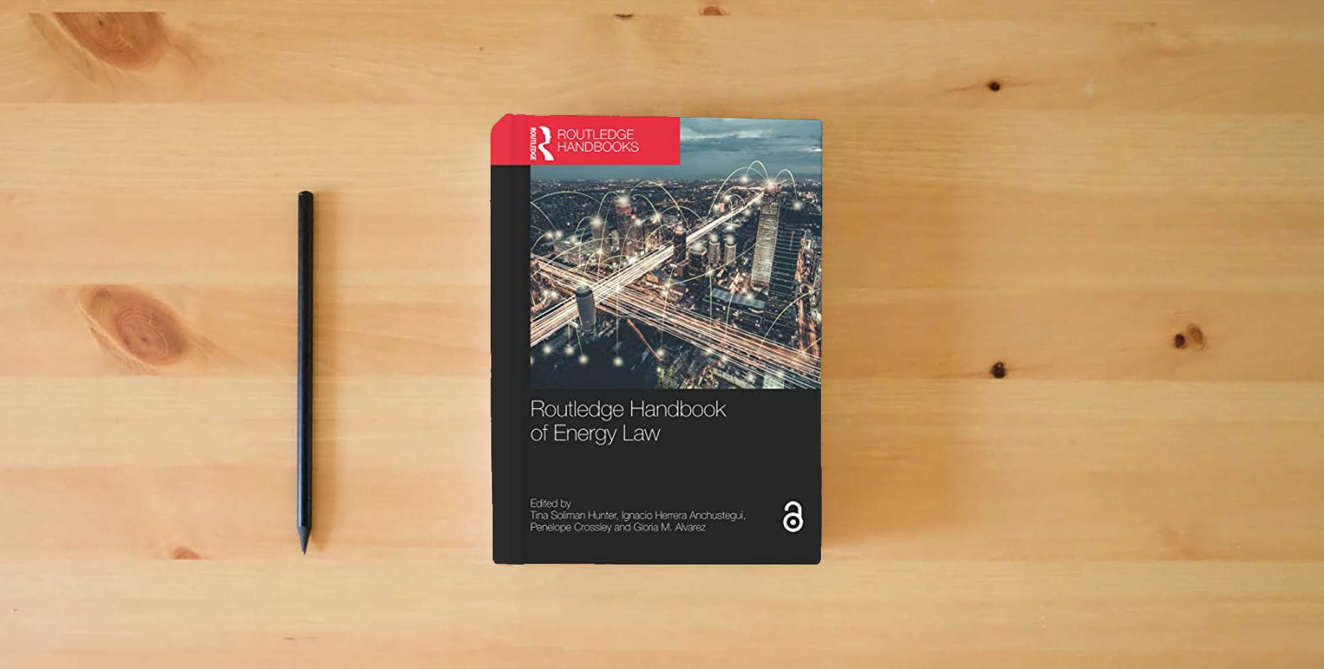 The book Routledge Handbook of Energy Law (Routledge Handbooks in Law) is on the table