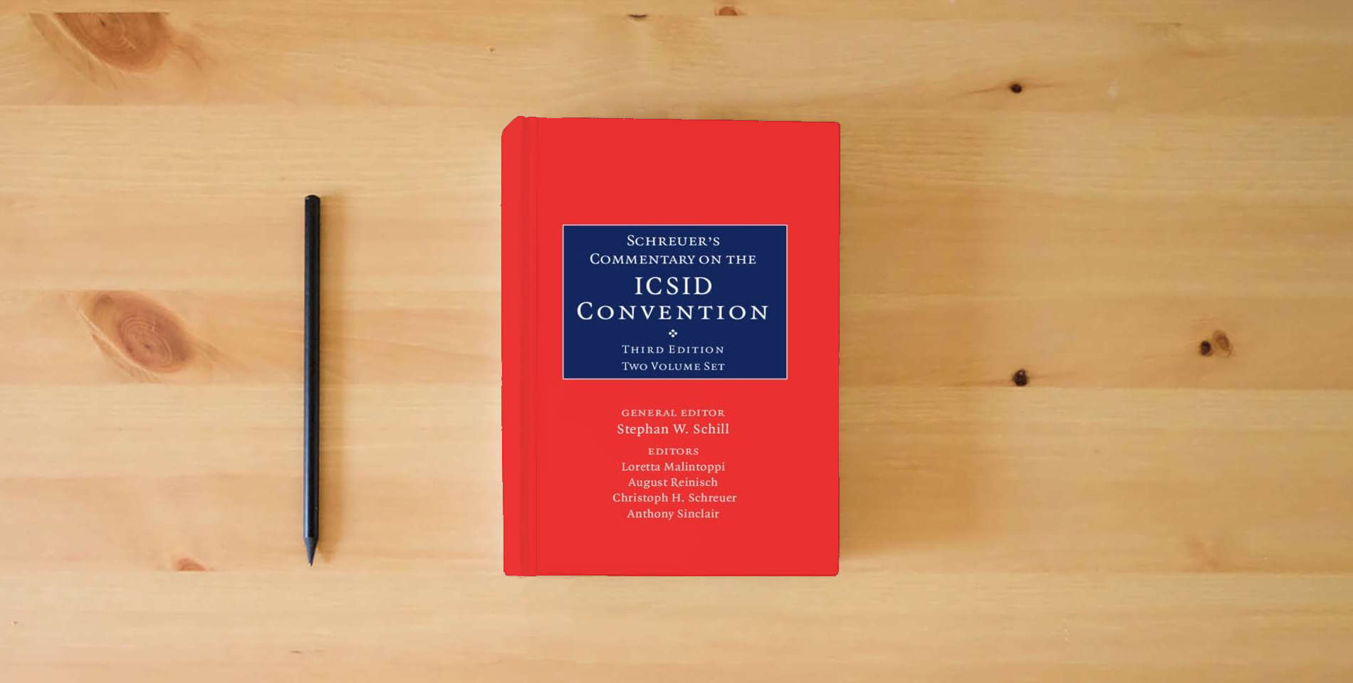 The book Schreuer's Commentary on the ICSID Convention 2 Volume Hardback Set: A Commentary on the Convention on the Settlement of Investment Disputes between States and Nationals of Other States is on the table
