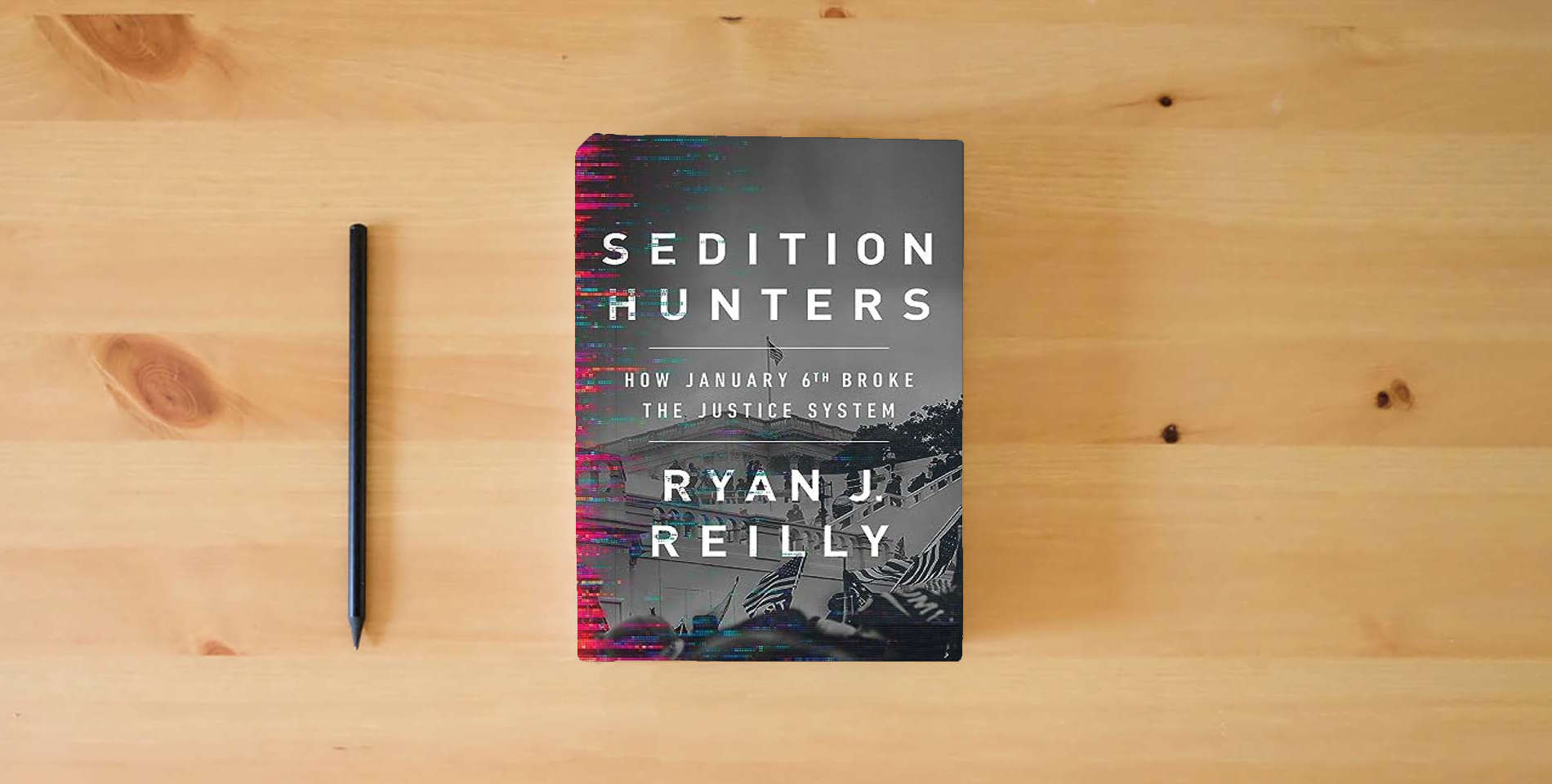 The book Sedition Hunters: How January 6th Broke the Justice System is on the table