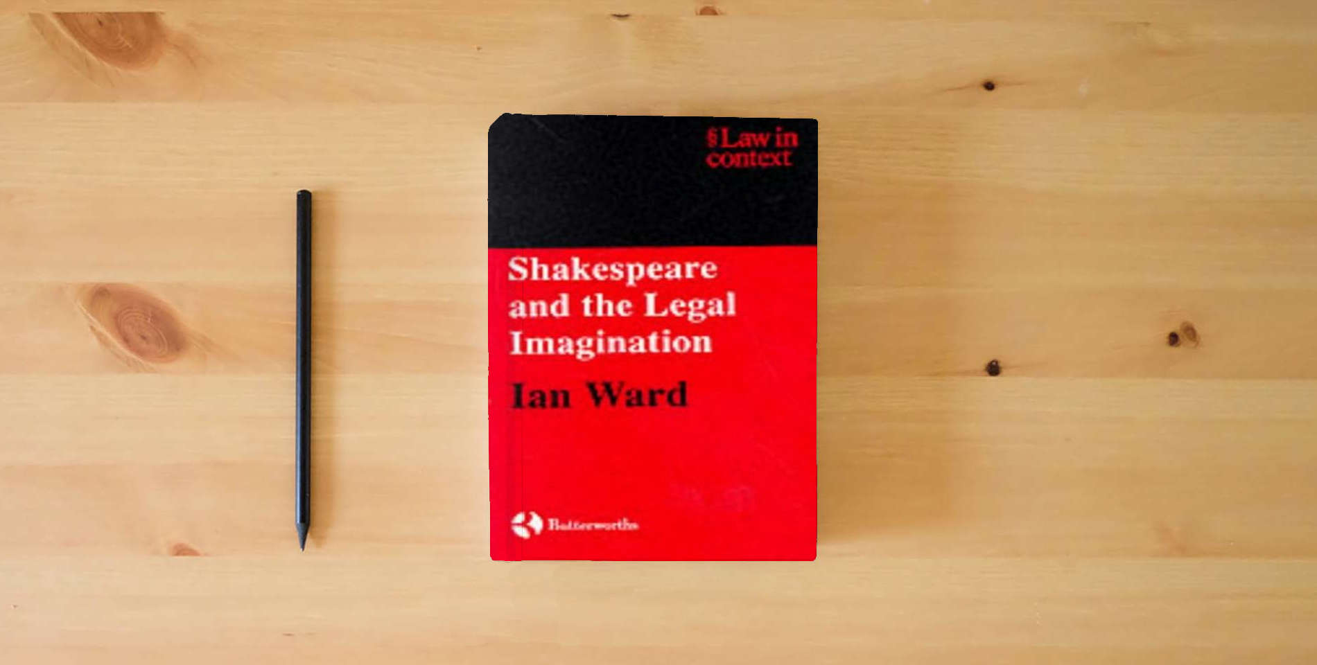 The book Shakespeare and the Legal Imagination (Law in Context) is on the table