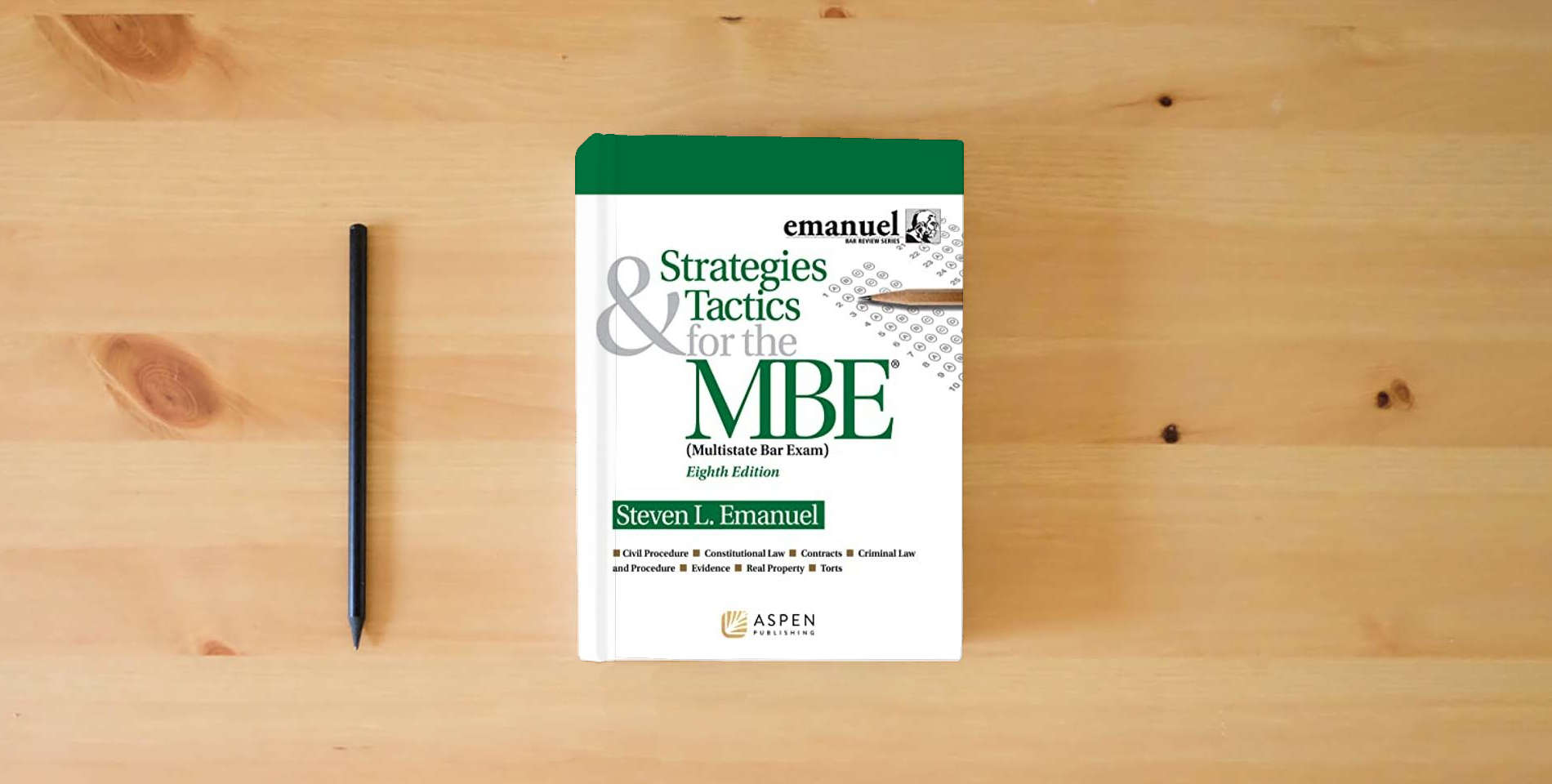 The book Strategies & Tactics for the MBE (Emanuel Bar Review) (Bar Review Series) is on the table