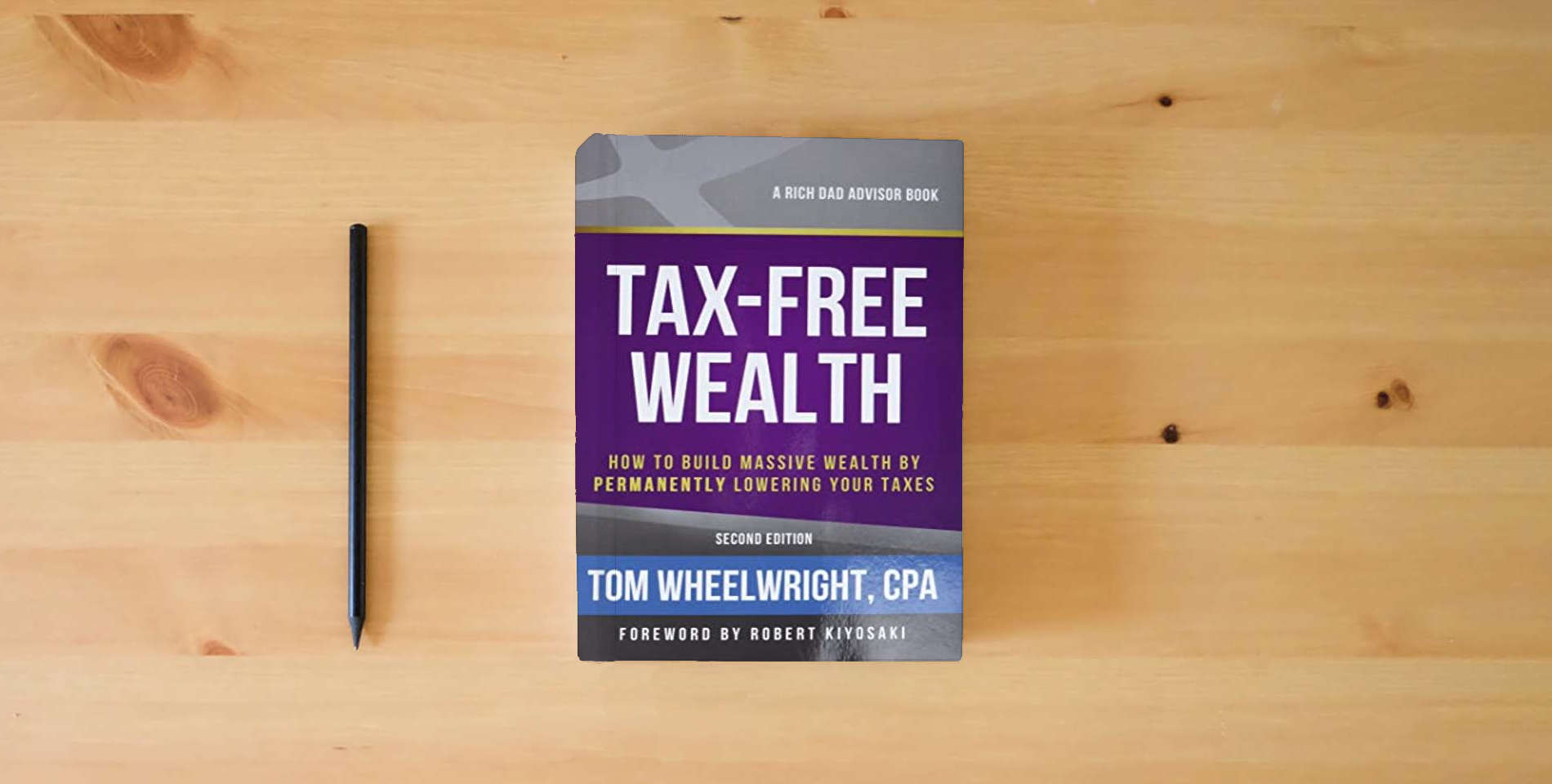 The book Tax-Free Wealth: How to Build Massive Wealth by Permanently Lowering Your Taxes (Rich Dad Advisors) is on the table