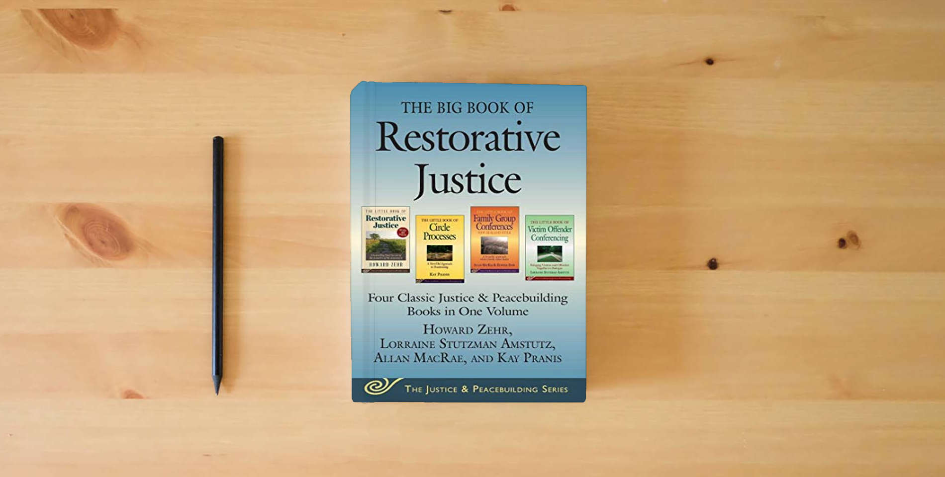 The book The Big Book of Restorative Justice: Four Classic Justice & Peacebuilding Books in One Volume is on the table