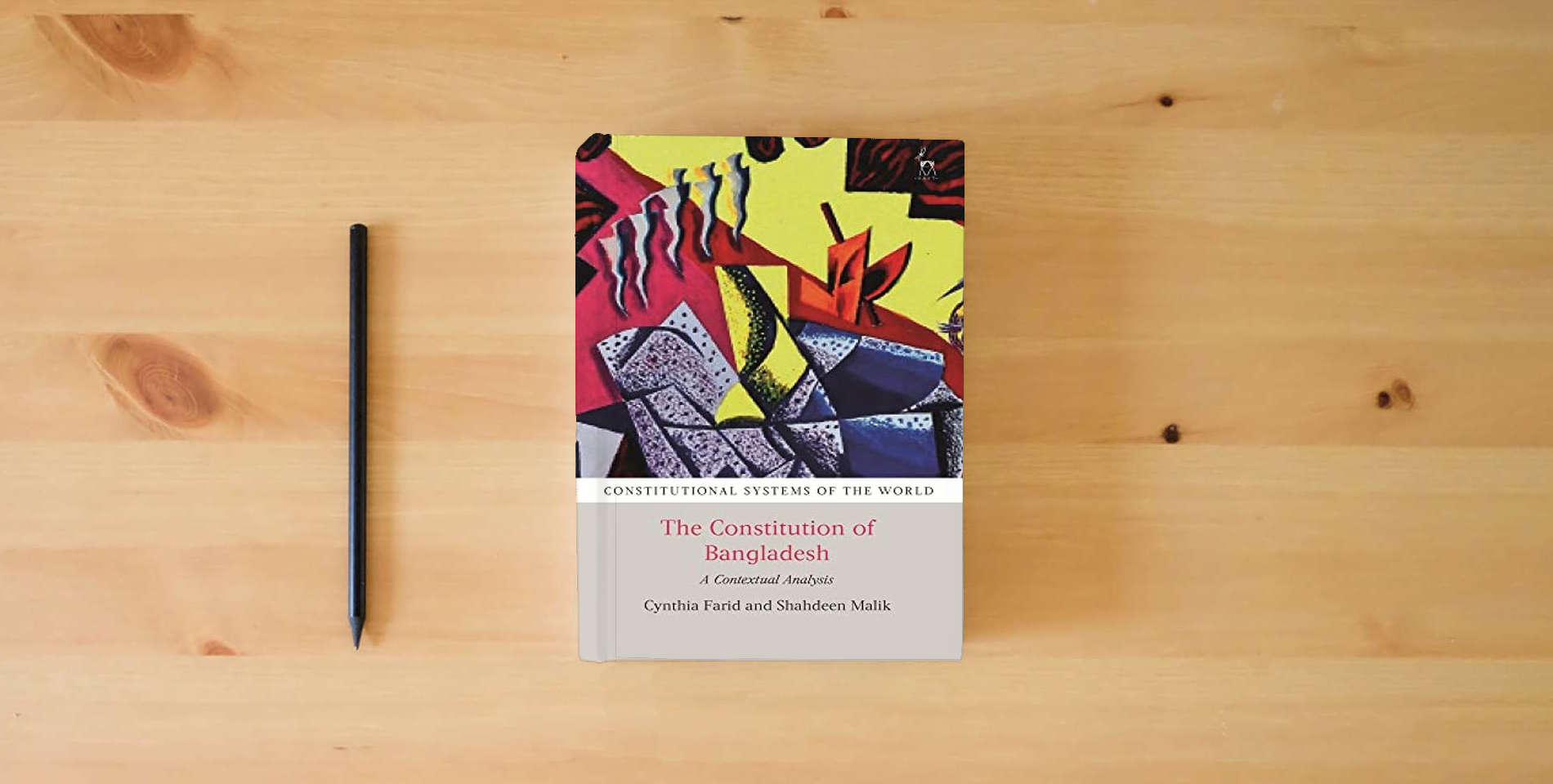The book The Constitution of Bangladesh: A Contextual Analysis (Constitutional Systems of the World) is on the table