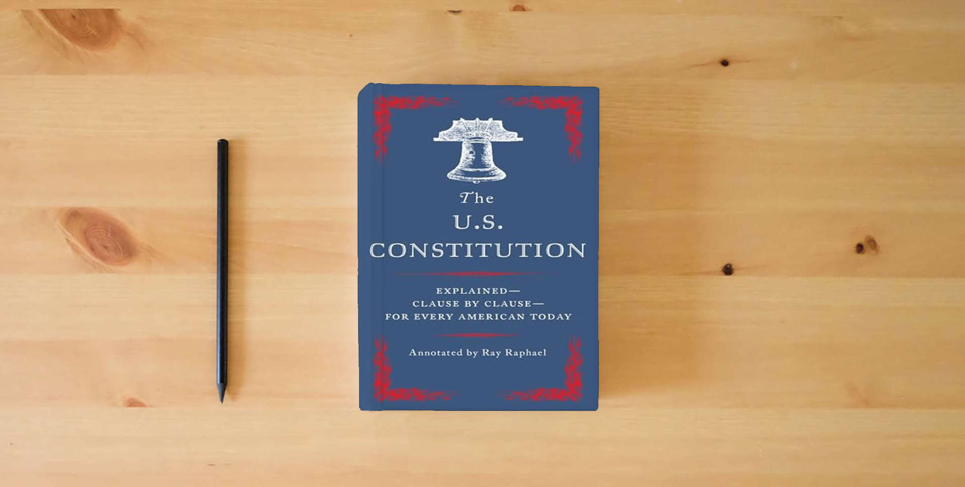 The book The U.S. Constitution: Explained--Clause by Clause--for Every American Today is on the table