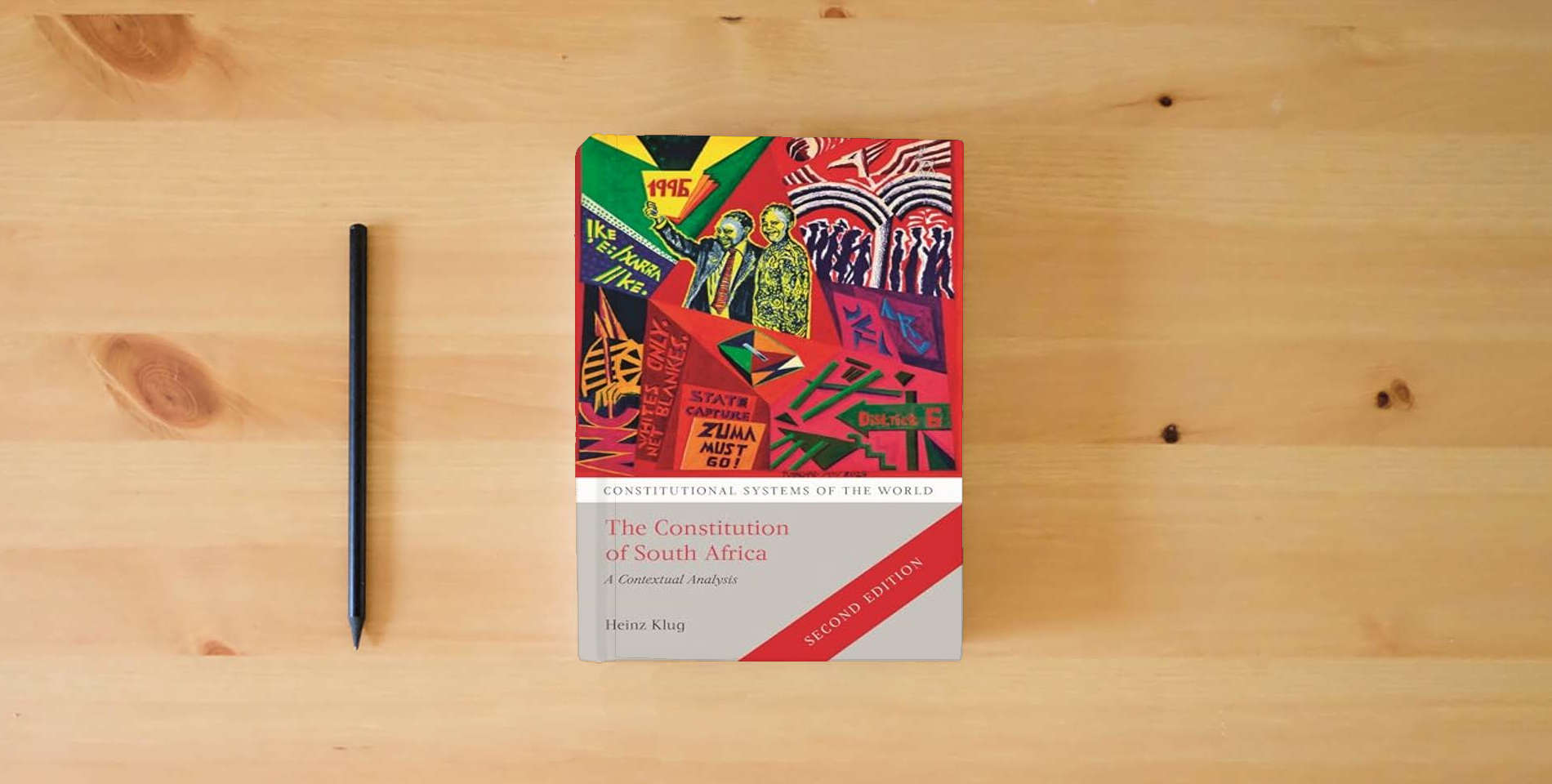 The book The Constitution of South Africa: A Contextual Analysis (Constitutional Systems of the World) is on the table
