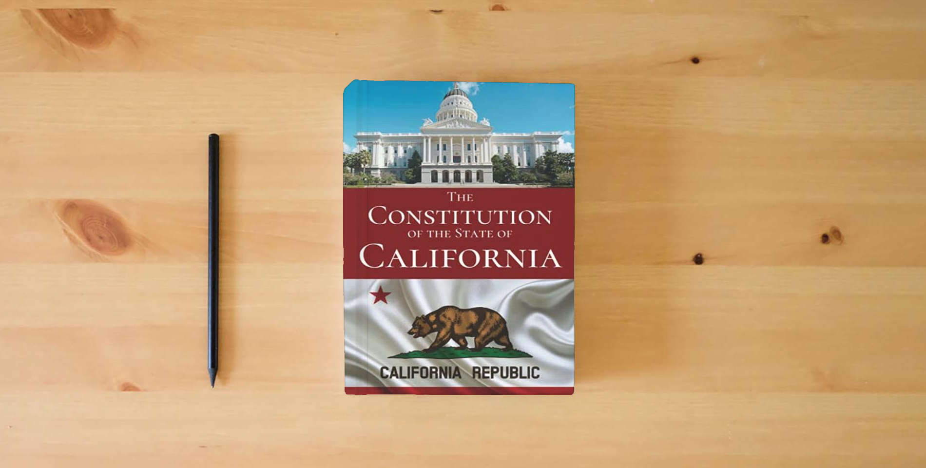 The book The Constitution of the State of California is on the table