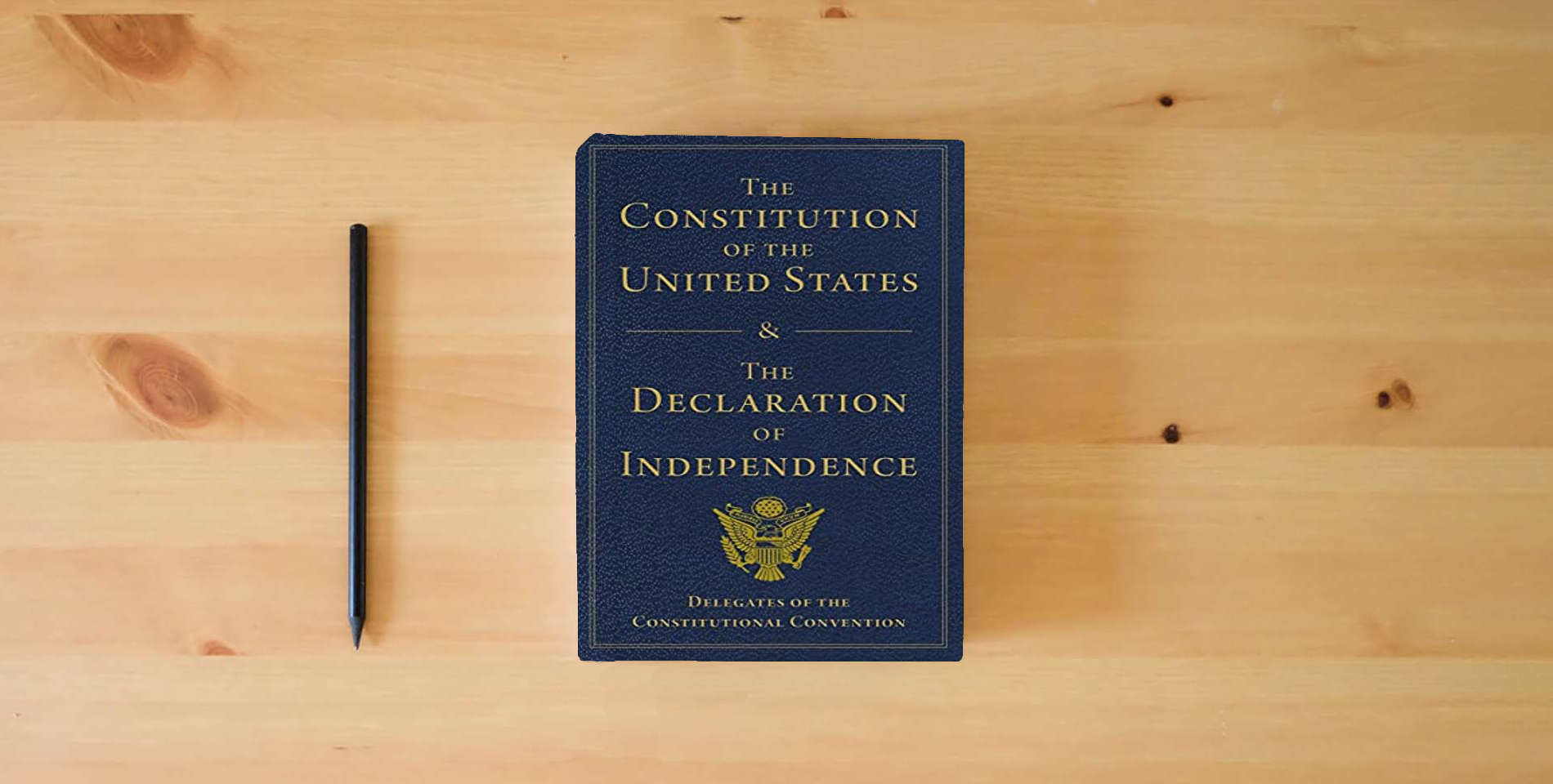 The book The Constitution of the United States and The Declaration of Independence is on the table