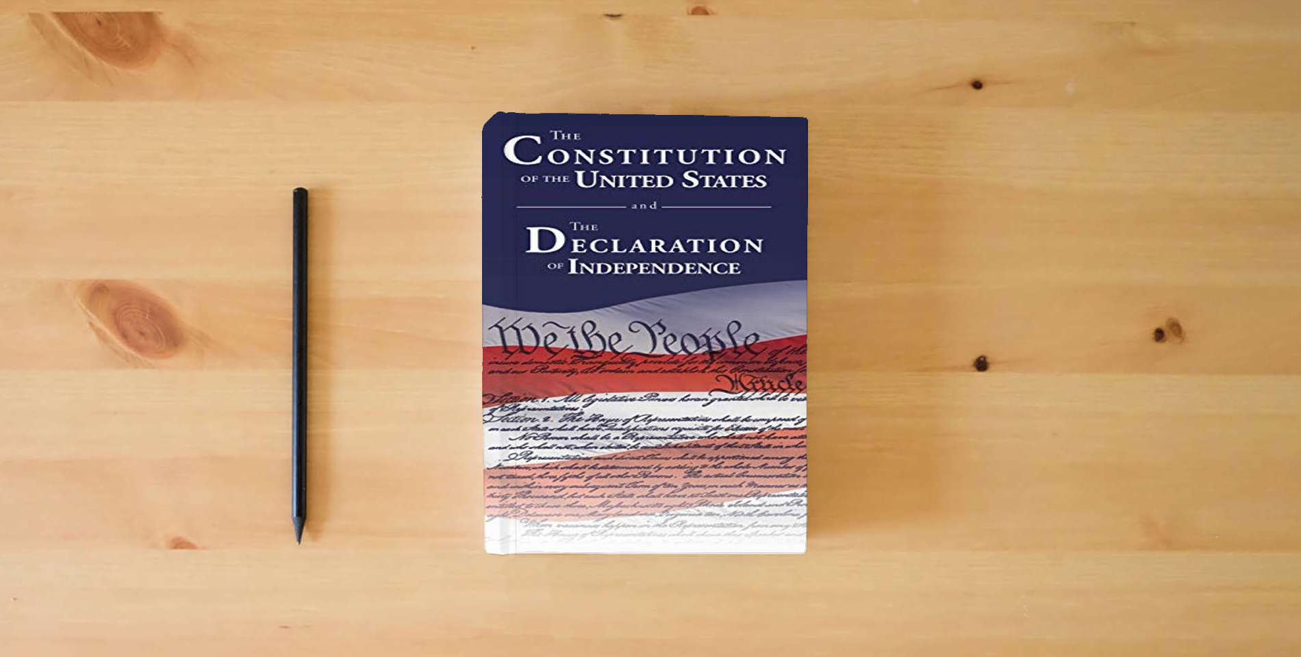 The book The Constitution of the United States and The Declaration of Independence is on the table