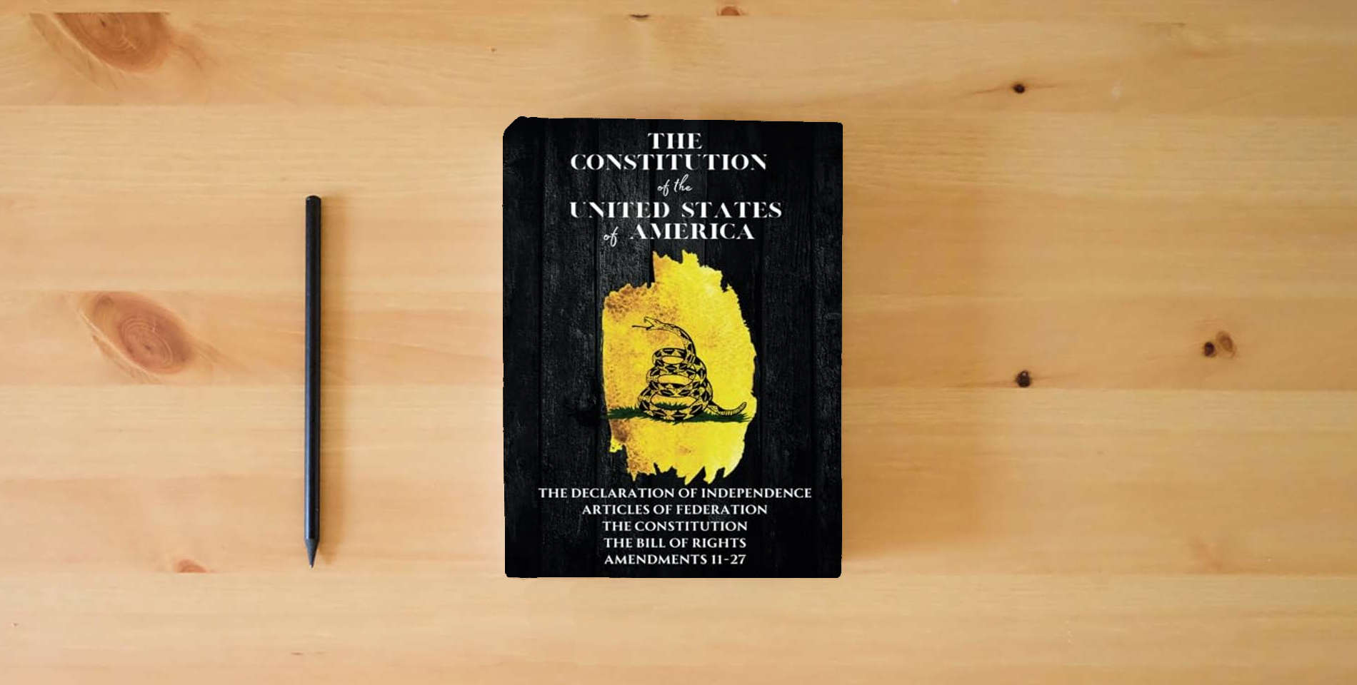 The book The Constitution of the United States: The Declaration of Independence, The Bill of Rights is on the table