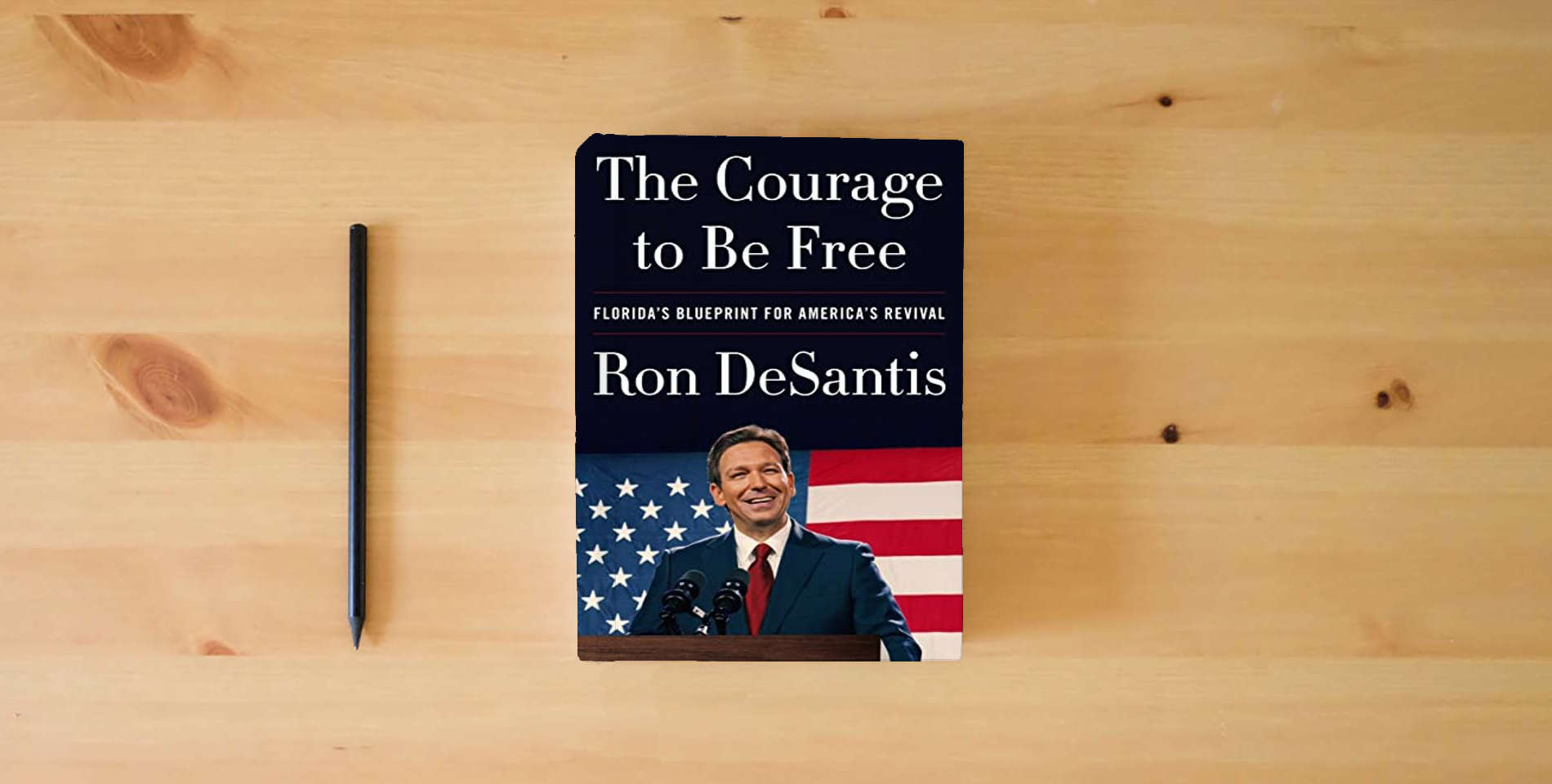 The book The Courage to Be Free: Florida's Blueprint for America's Revival is on the table
