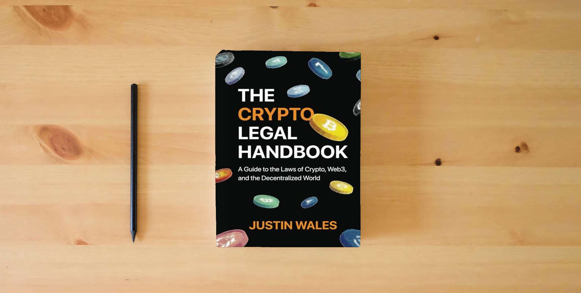 The book The Crypto Legal Handbook: A Guide to the Laws of Crypto, Web3, and the Decentralized World is on the table
