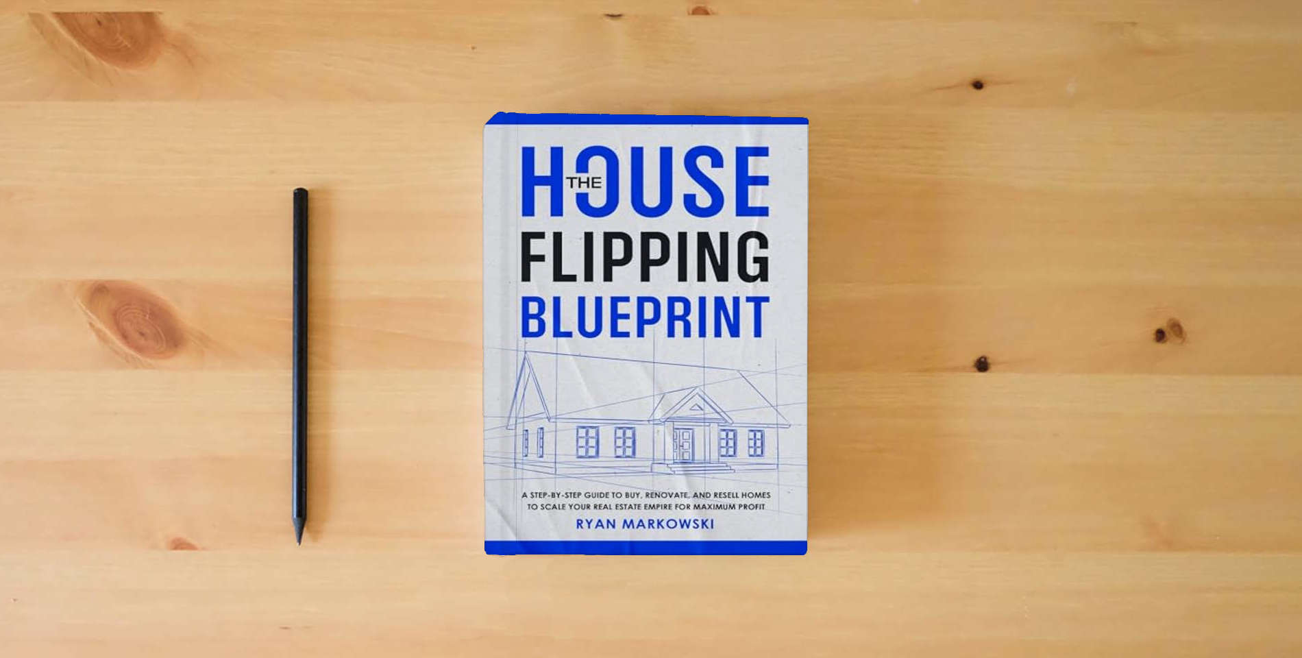 The book The House Flipping Blueprint: A Step-by-Step Guide to Buy, Renovate, and Resell Homes to Scale Your Real Estate Empire for Maximum Profit is on the table