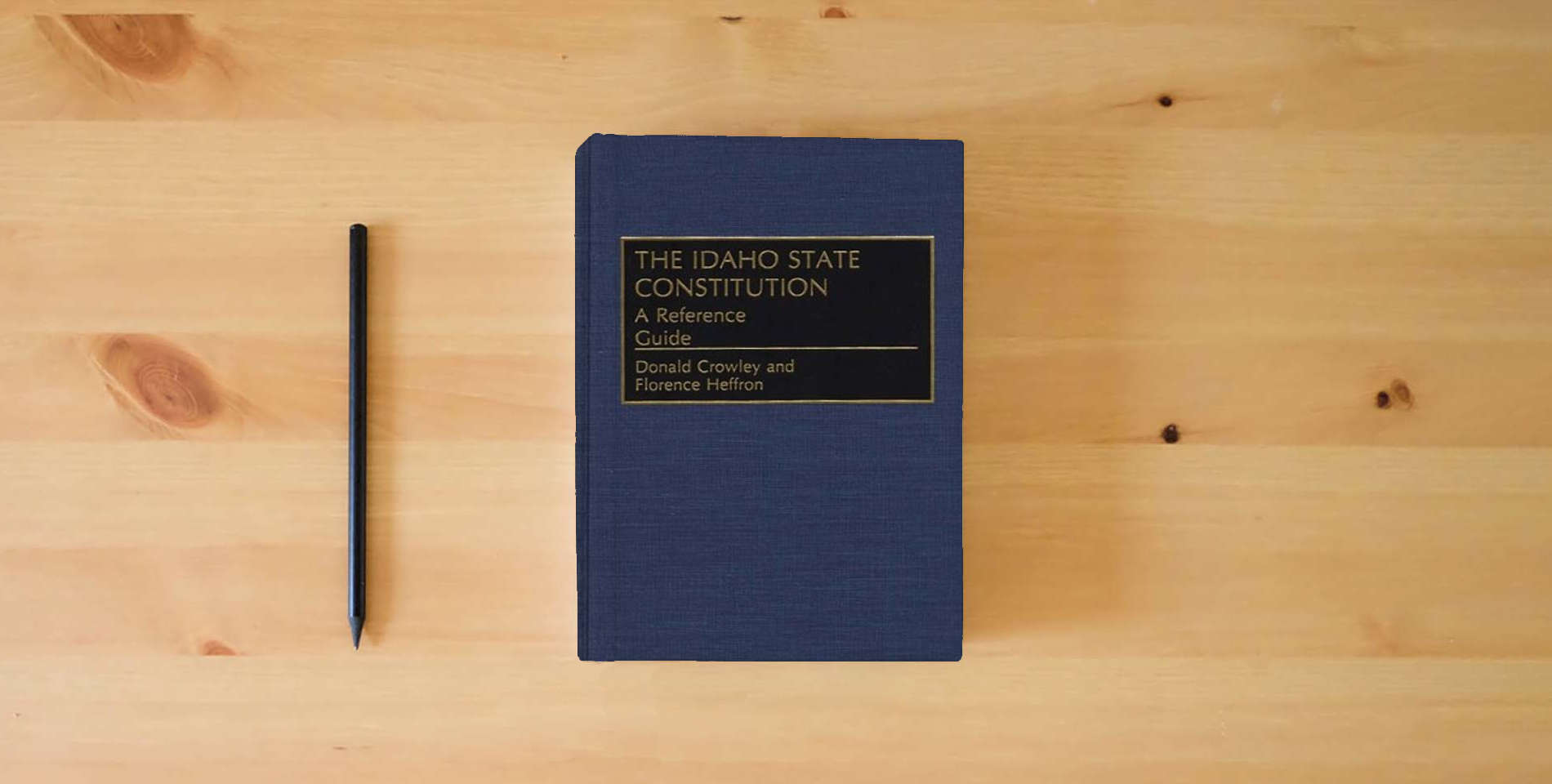 The book The Idaho State Constitution: A Reference Guide (Reference Guides to the State Constitutions of the United States) is on the table