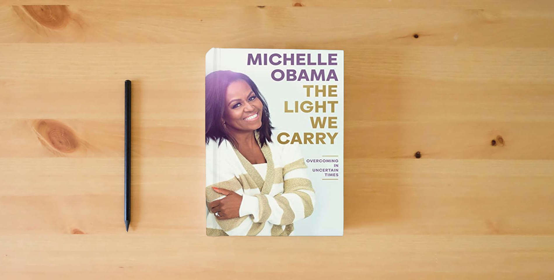 The book The Light We Carry: Overcoming in Uncertain Times is on the table