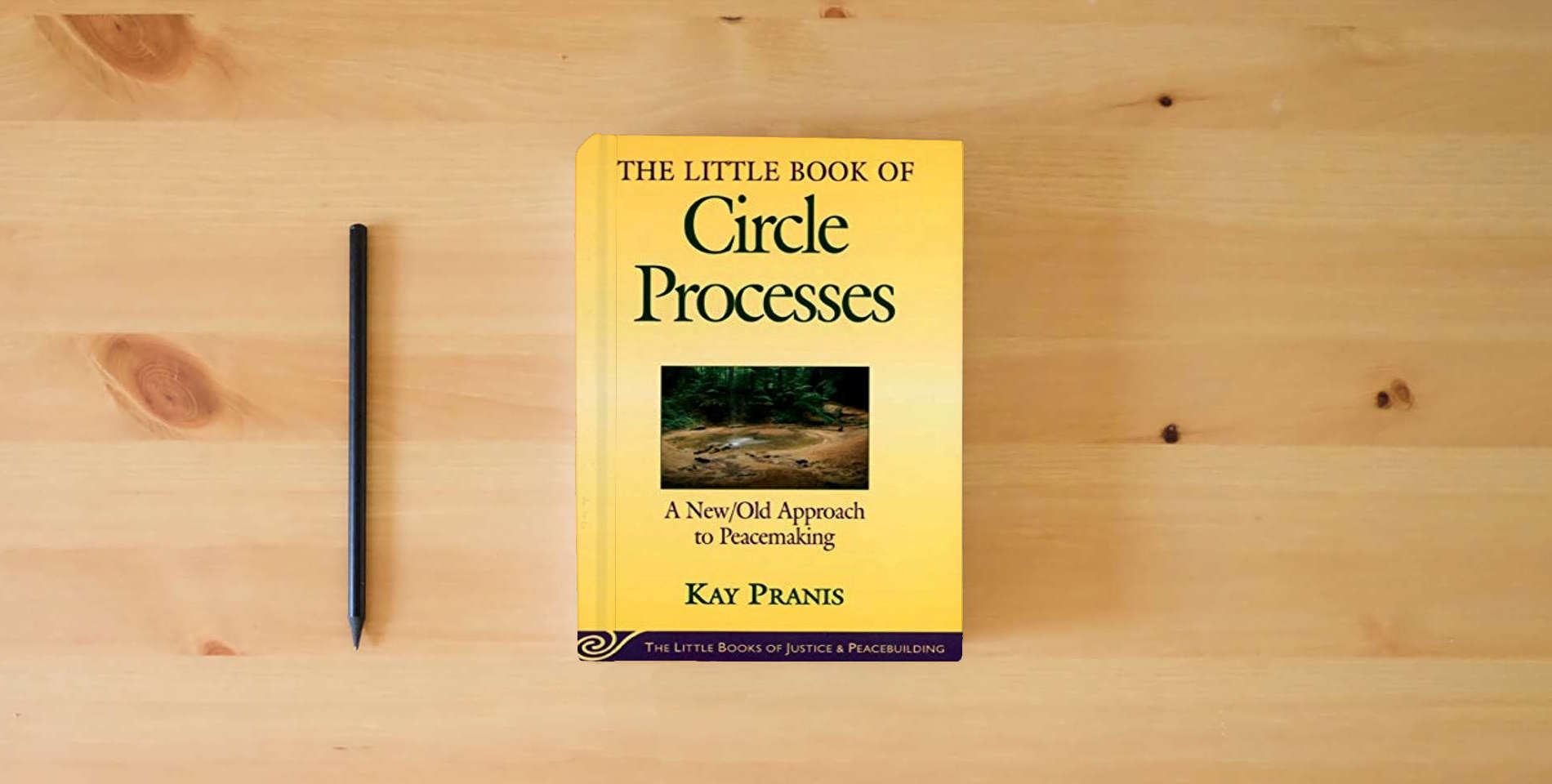 The book The Little Book of Circle Processes : A New/Old Approach to Peacemaking (The Little Books of Justice and Peacebuilding Series) is on the table