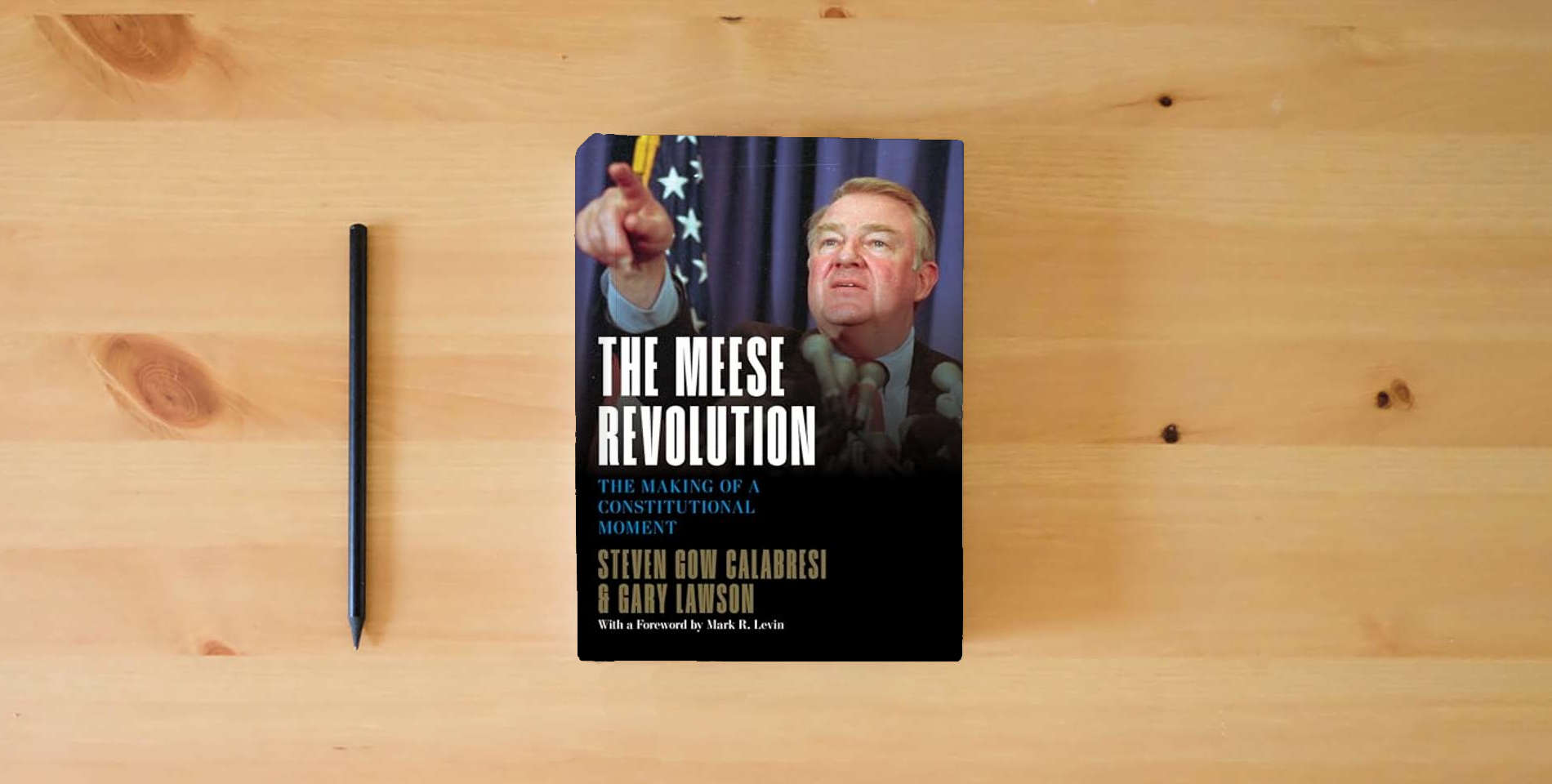 The book The Meese Revolution: The Making of a Constitutional Moment is on the table