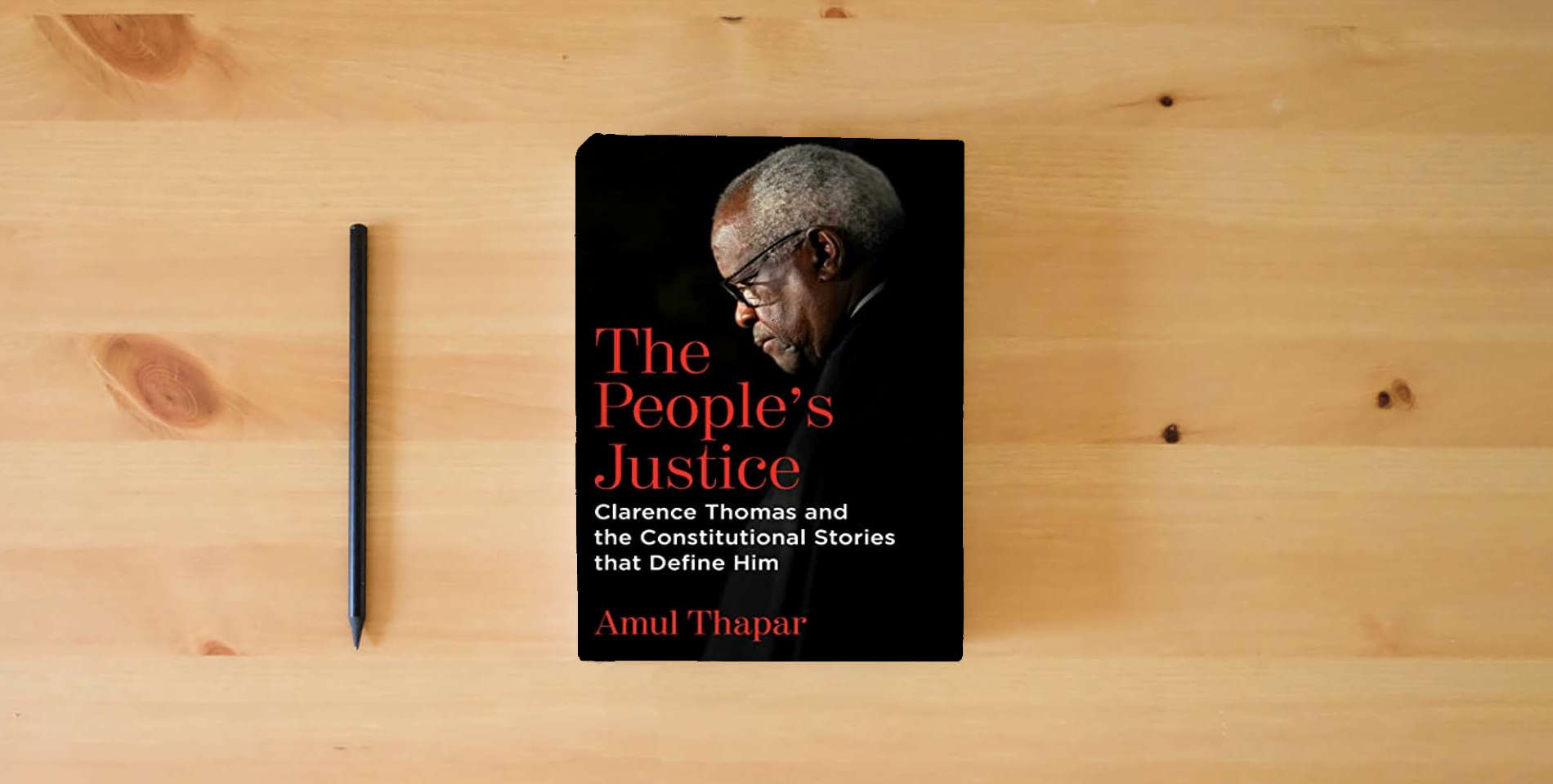 The book The People's Justice: Clarence Thomas and the Constitutional Stories that Define Him is on the table