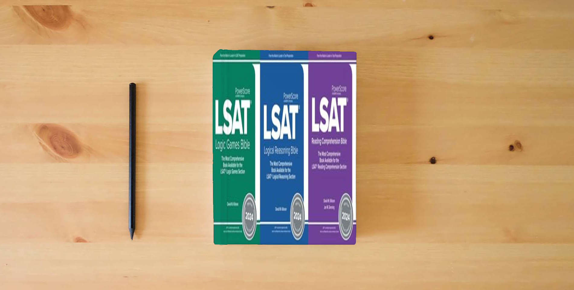 The book The PowerScore LSAT Bible Trilogy 2024: Prep Strategies for Each Section of the LSAT - Logic Games, Reading Comprehension, Logical Reasoning (LSAT Prep) is on the table