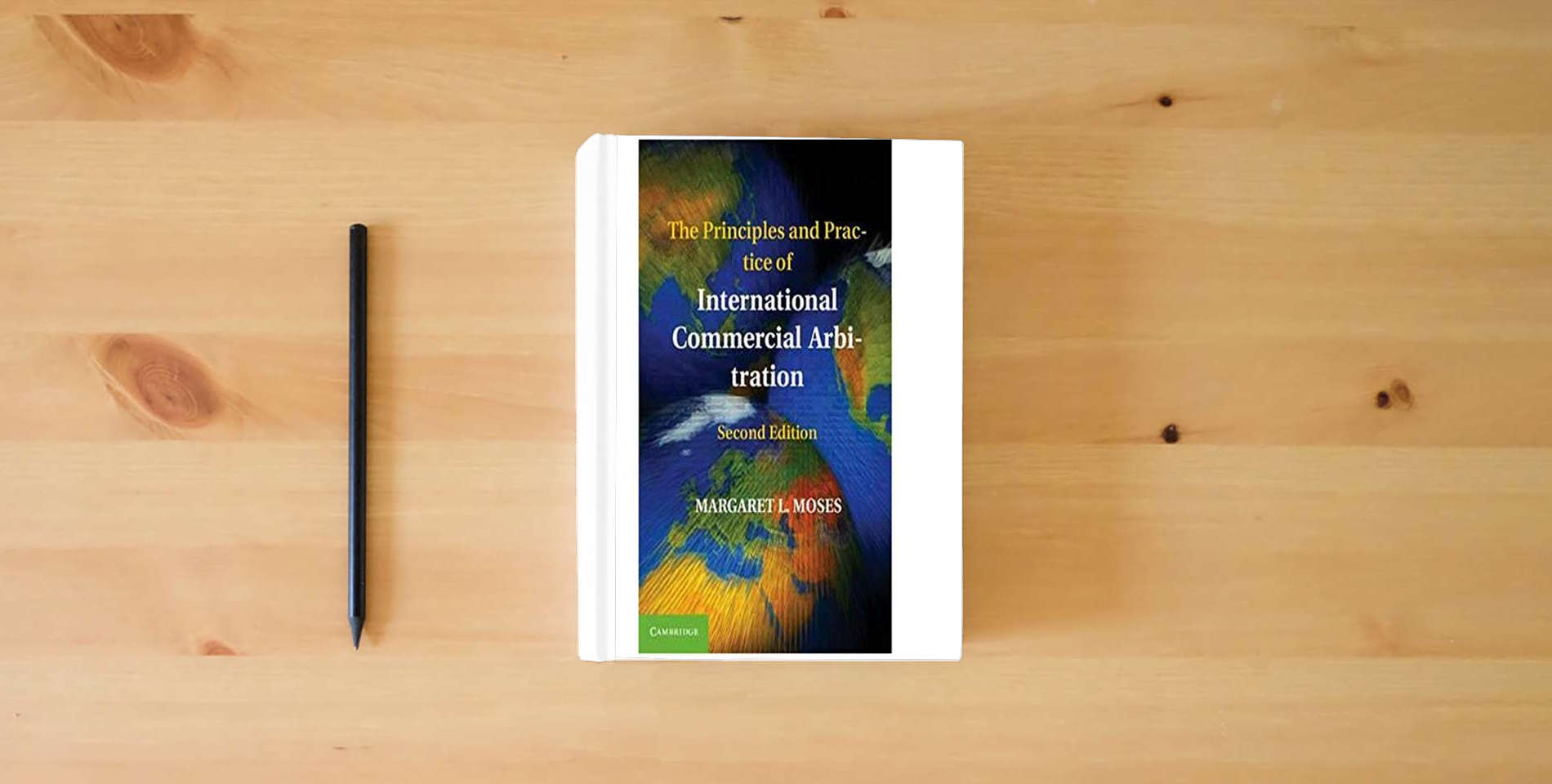 The book The Principles and Practice of International Commercial Arbitration is on the table