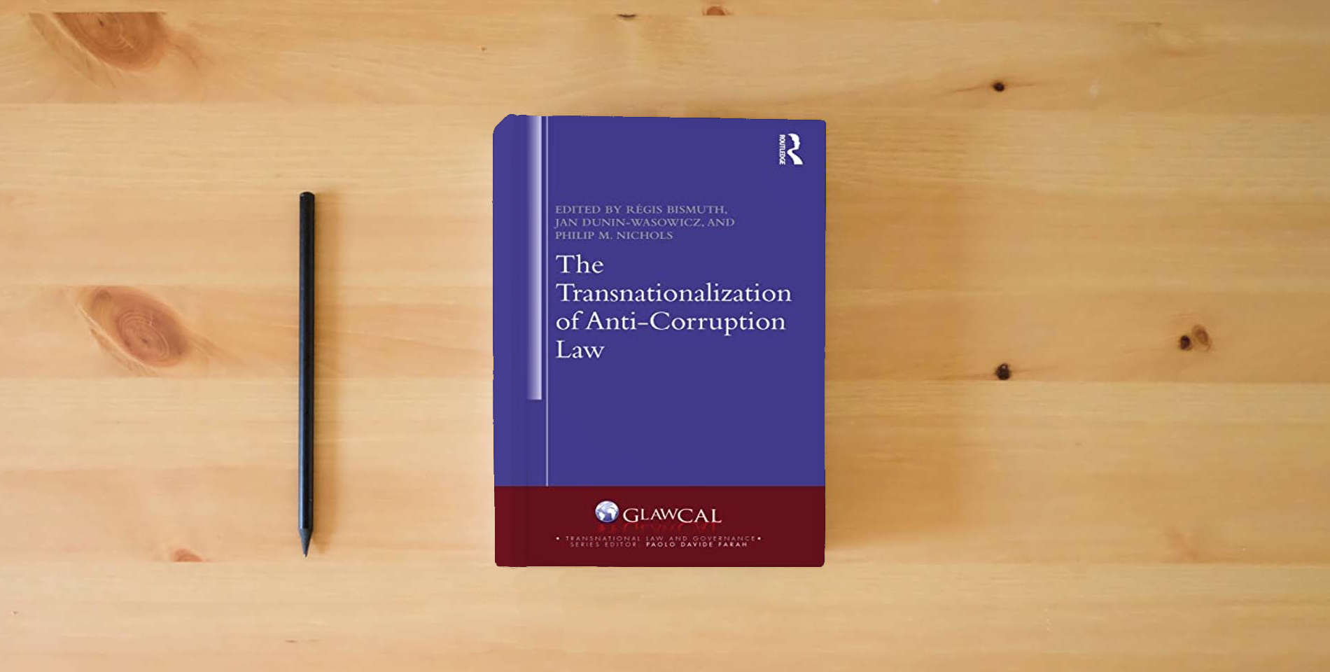 The book The Transnationalization of Anti-Corruption Law (Transnational Law and Governance) is on the table