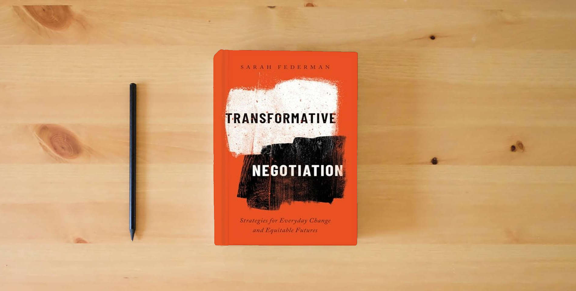 The book Transformative Negotiation: Strategies for Everyday Change and Equitable Futures is on the table