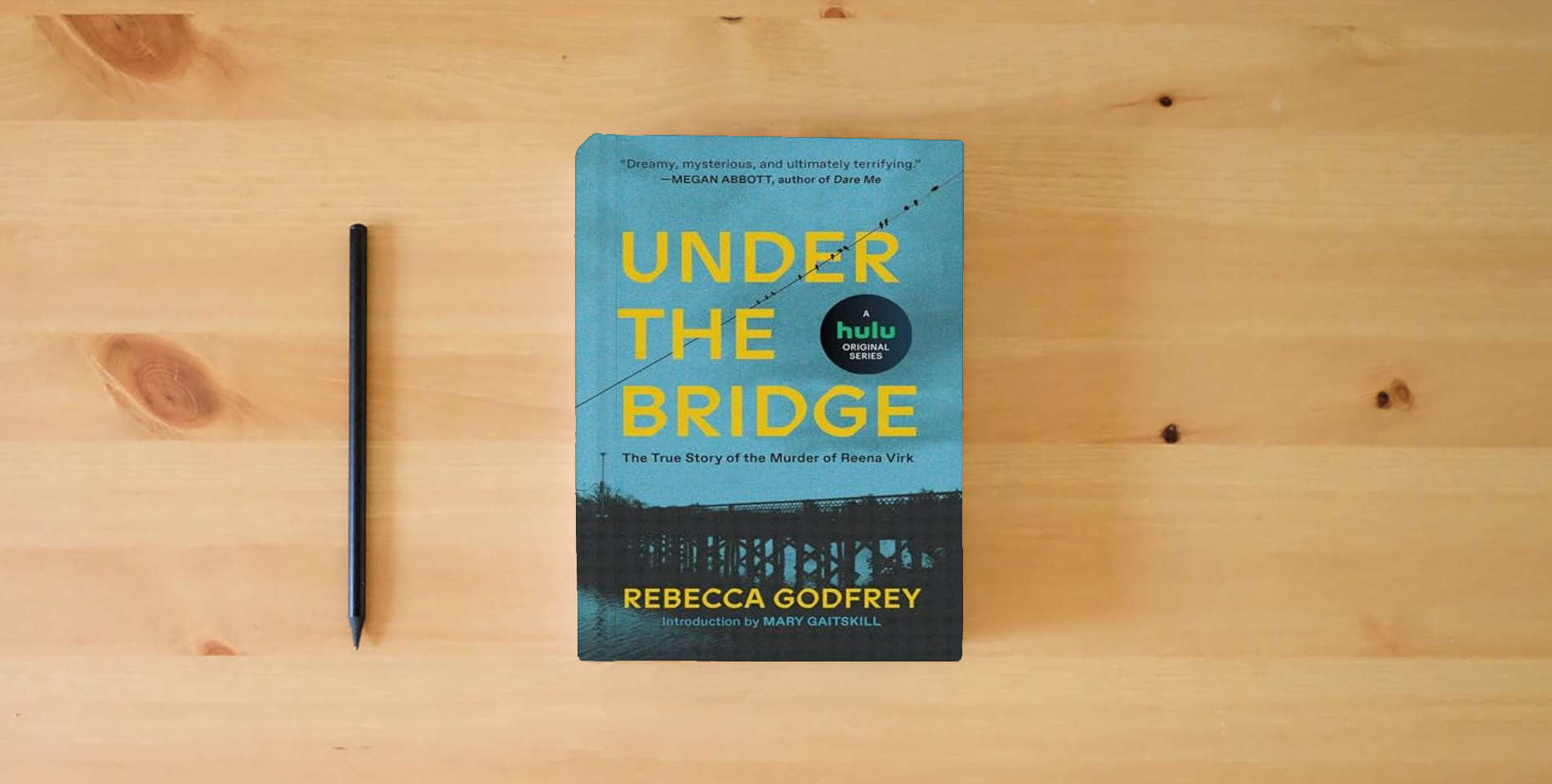 The book Under the Bridge is on the table