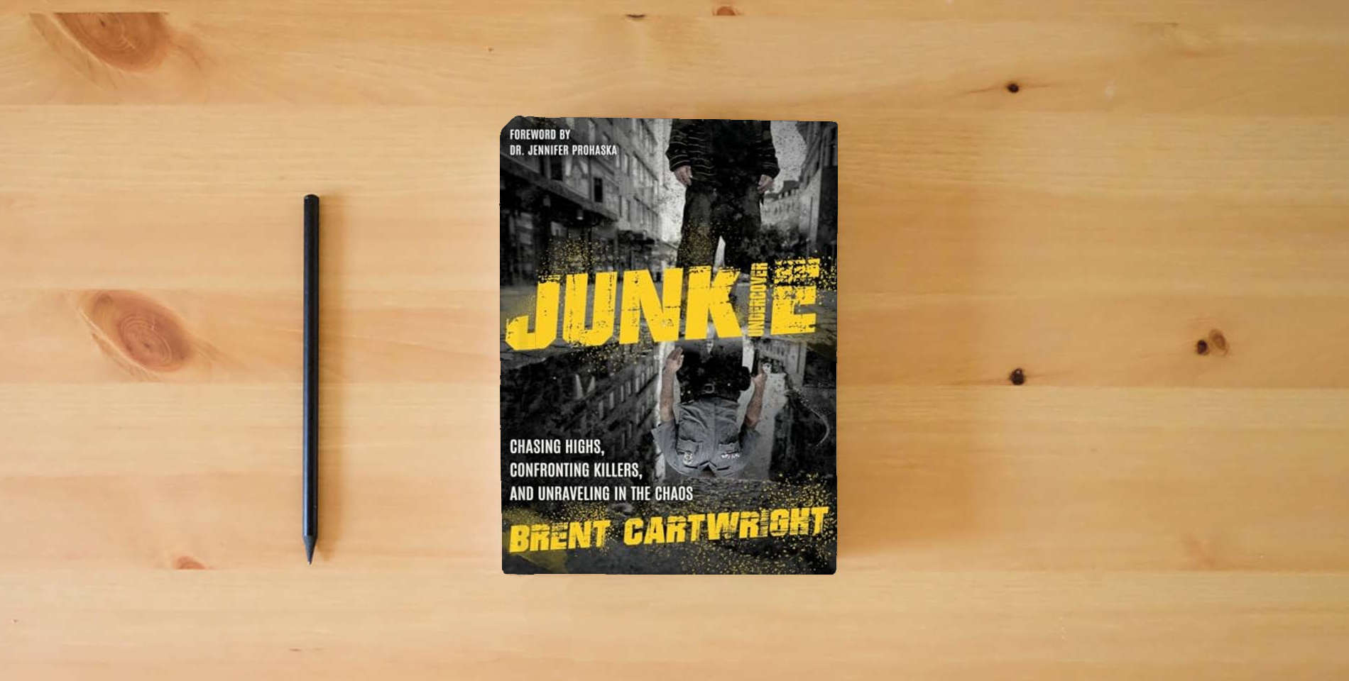 The book Undercover Junkie: Chasing Highs, Confronting Killers, and Unraveling in the Process is on the table